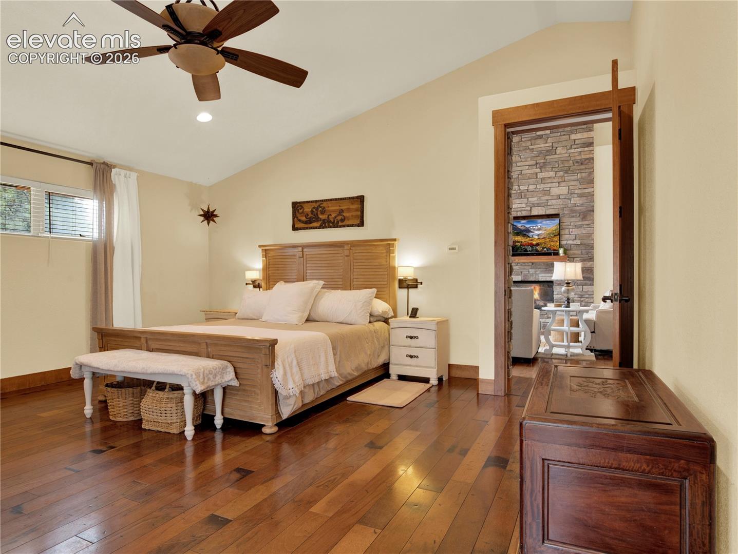 Primary bedroom comes with vaulted ceiling and beautiful hardwood flloors