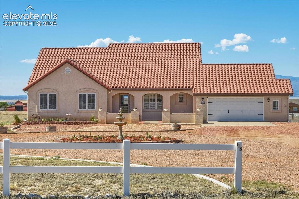 Welcoming covered entry with arched architectural details and a spacious front porch offering a comfortable place to enjoy the surrounding views.