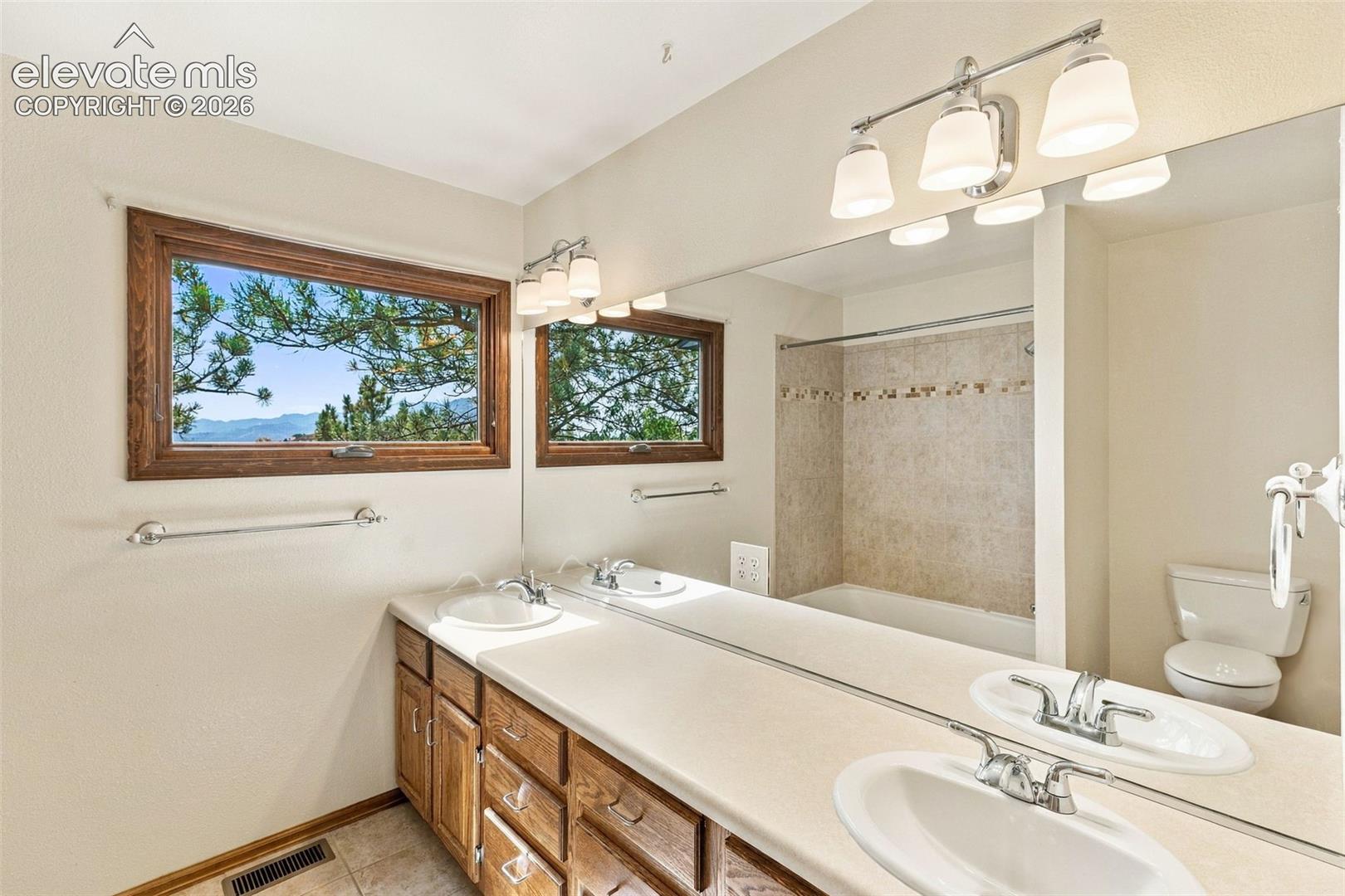 Upper level, hall bath has an amazing view, double vanities and a huge linen closet.