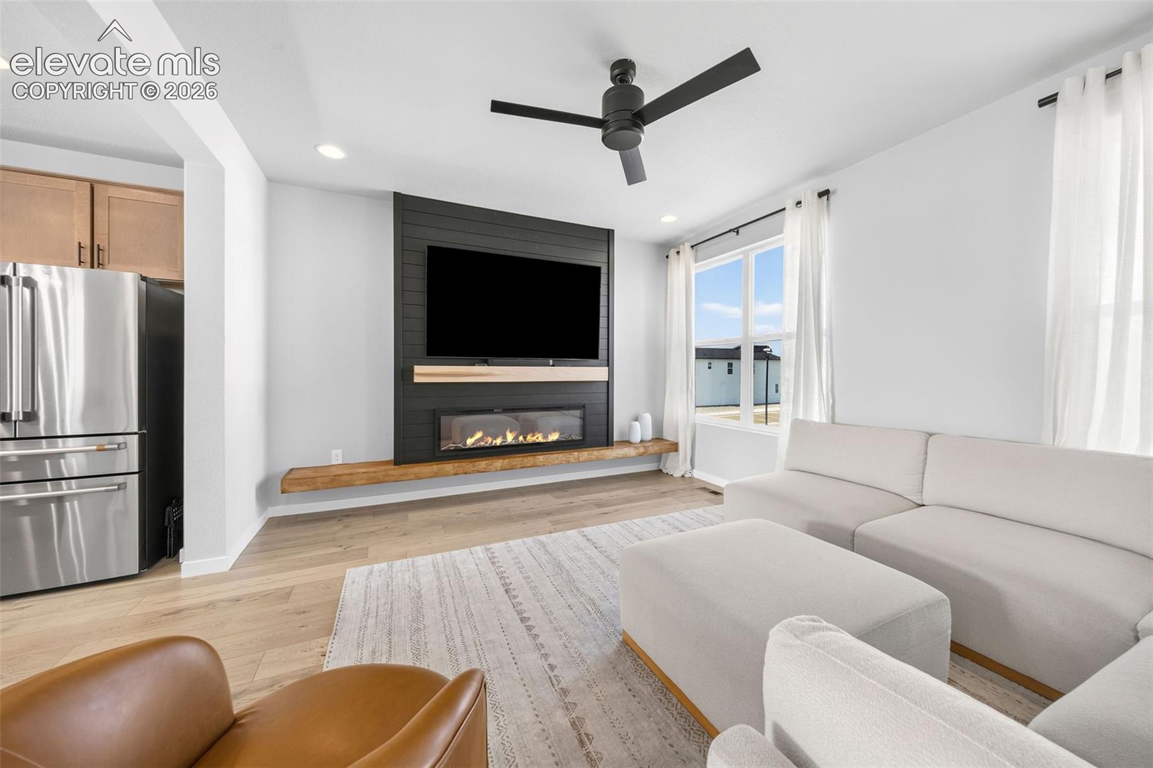 The feature wall is the perfect spot for your big-screen TV. Enjoy the fireplace year round while the kitchen is just to your left. 