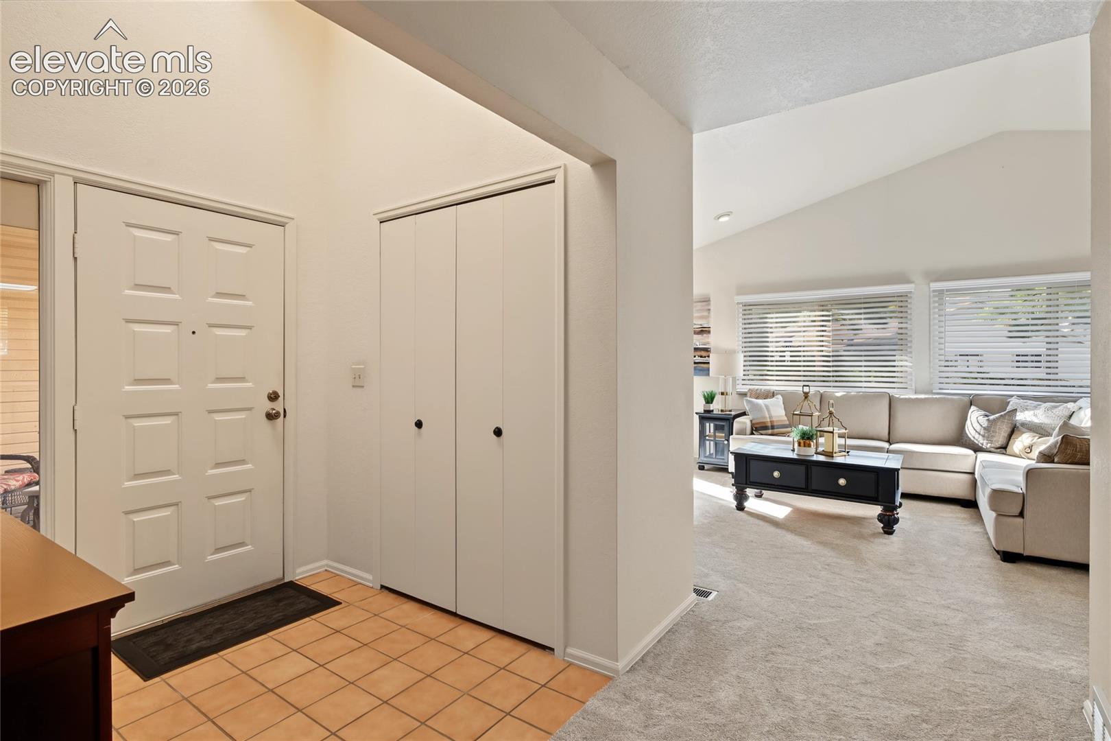 Entry with tiled flooring and a paneled front door