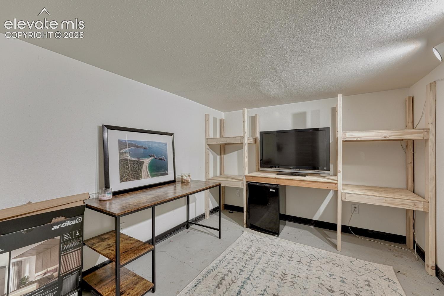 Custom-built wood shelving and desk system provides integrated storage and workspace