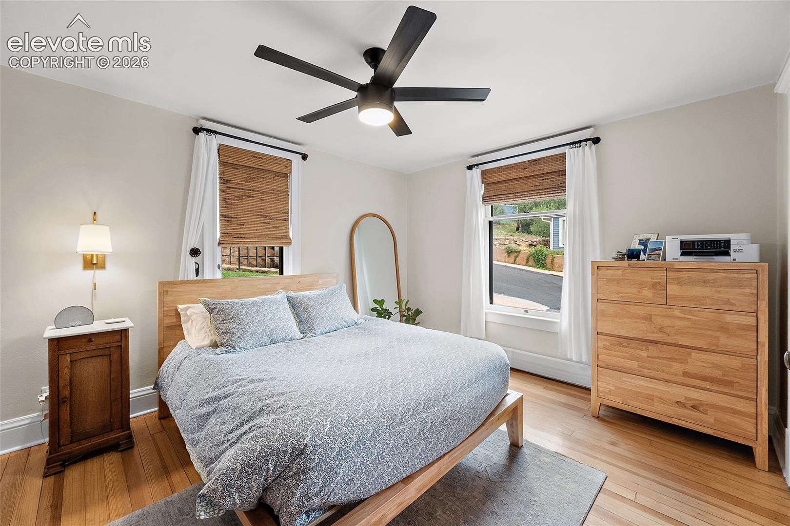 Spacious primary bedroom with blackout blinds.