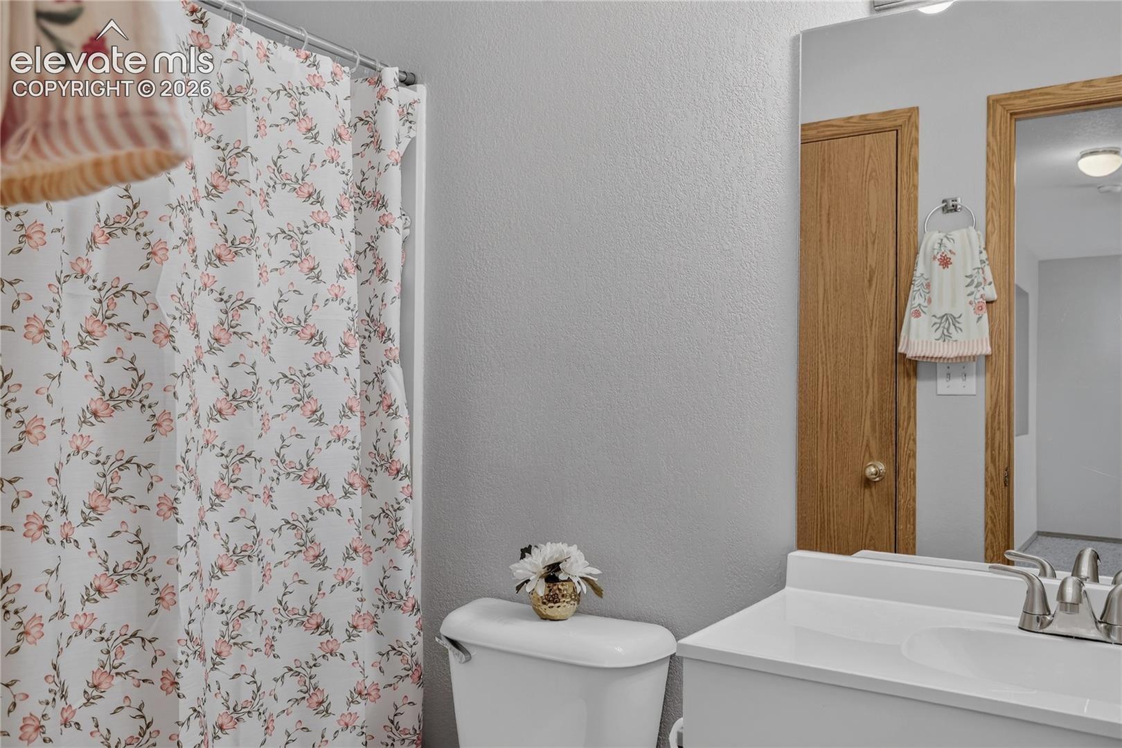 White vanity with integrated sink and chrome faucet