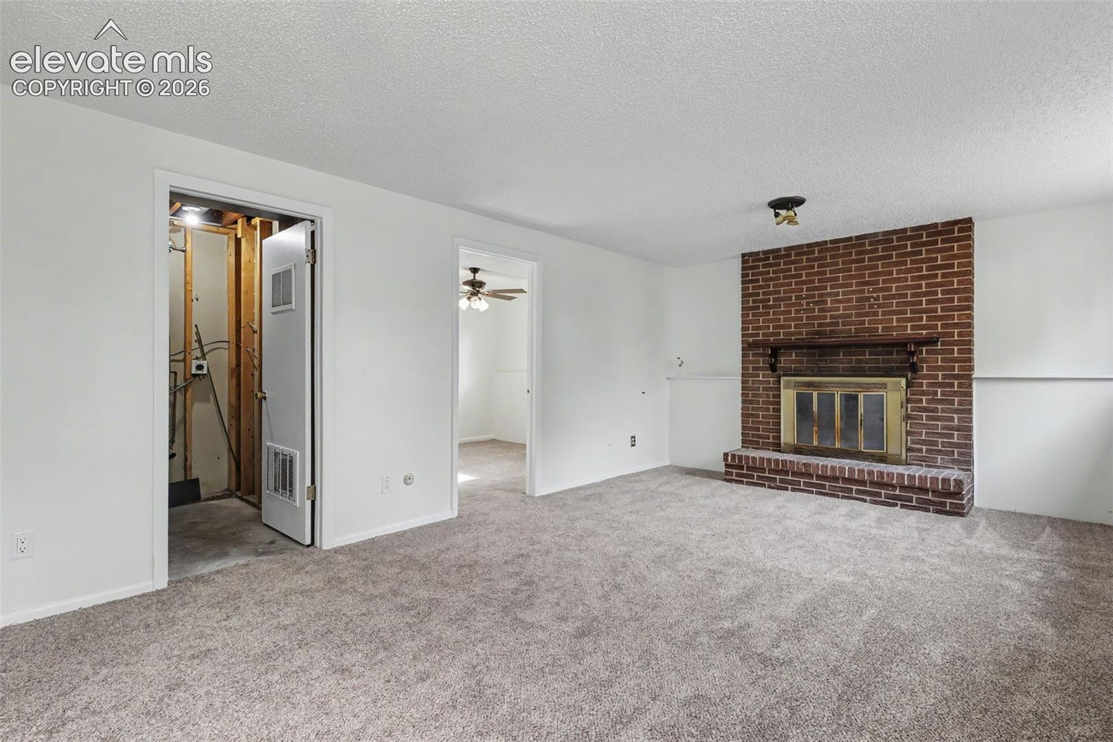 Brick fireplace creates a warm focal point in the lower level family room.