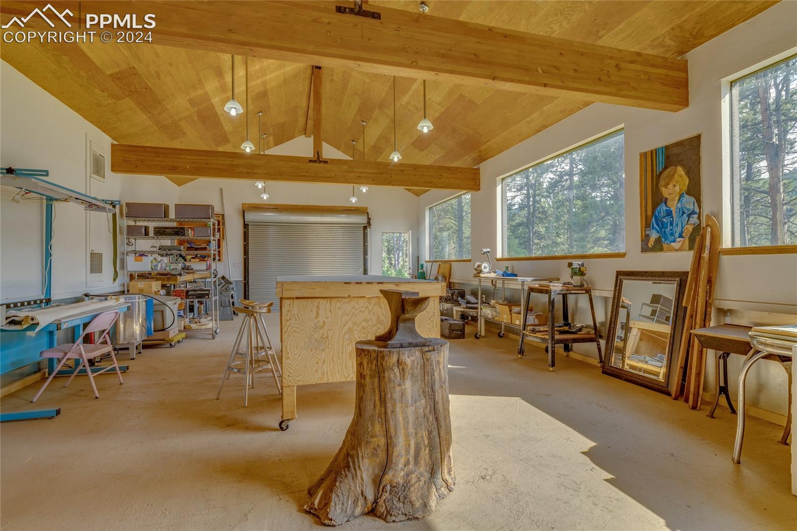Misc room featuring plenty of natural light, wooden ceiling, and vaulted ceiling with beams