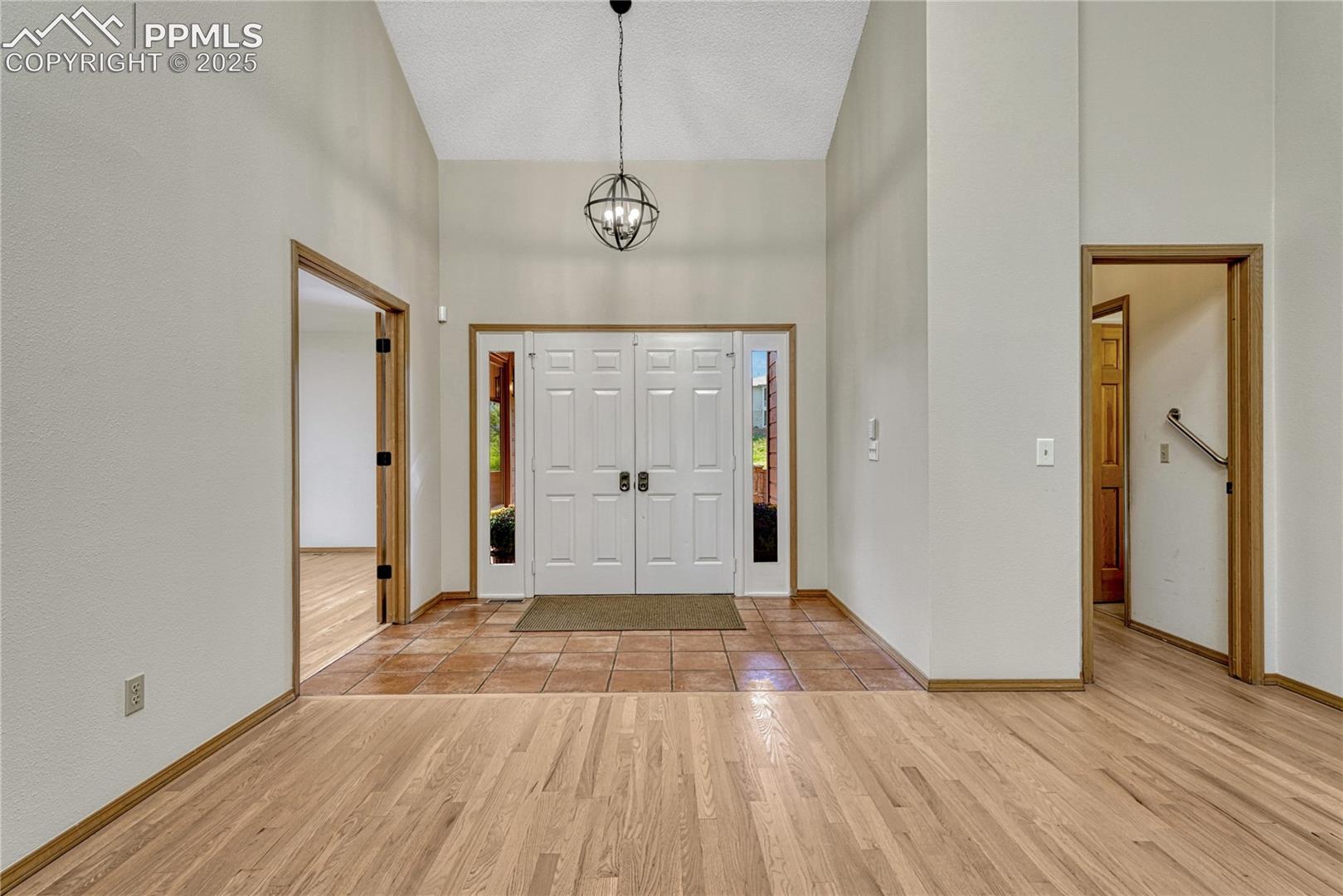 Vaulted Double Door Tiled Entry, Opens to Hardwood Floors