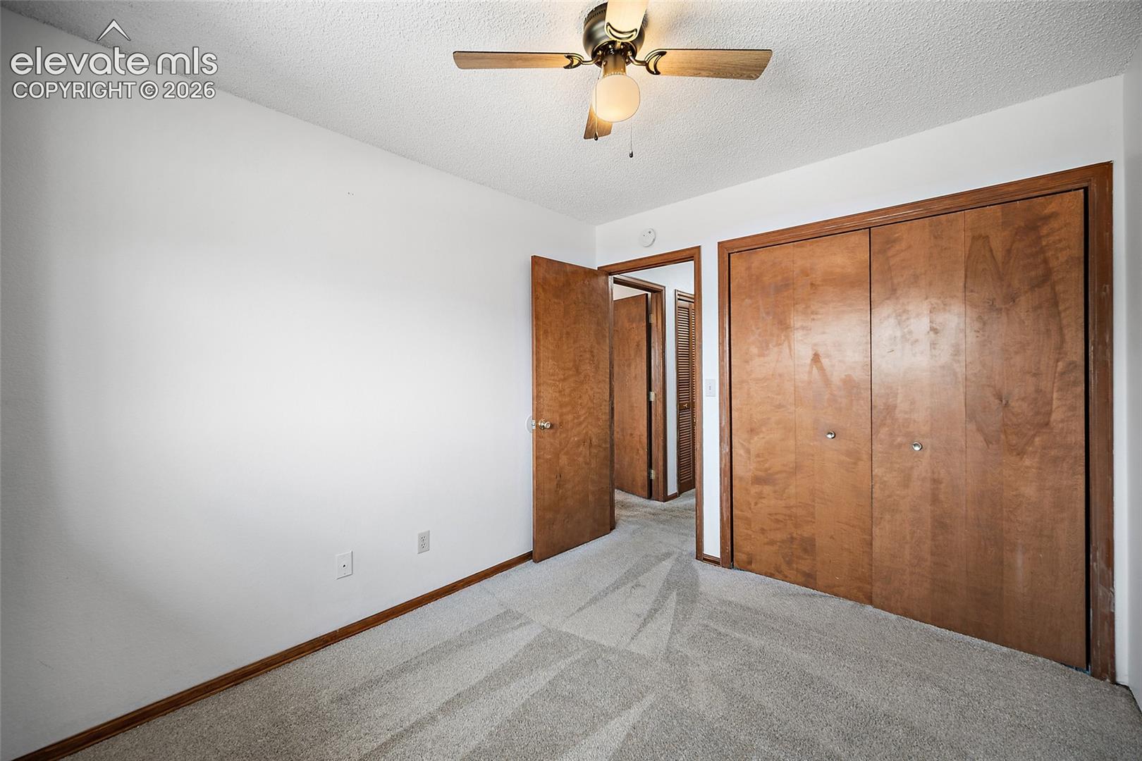 Bedroom featuring light gray patterned carpet and neutral white walls