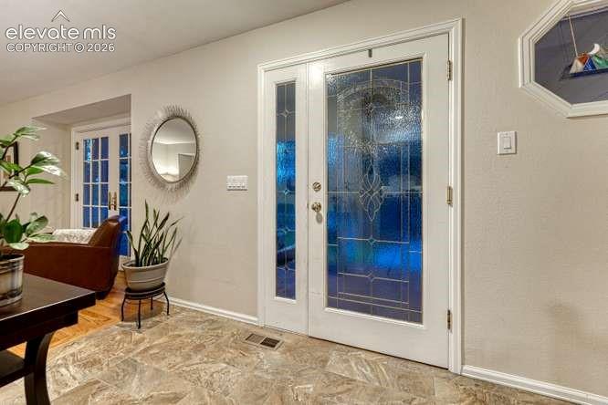 Welcoming leaded glass front door allows in natural light.