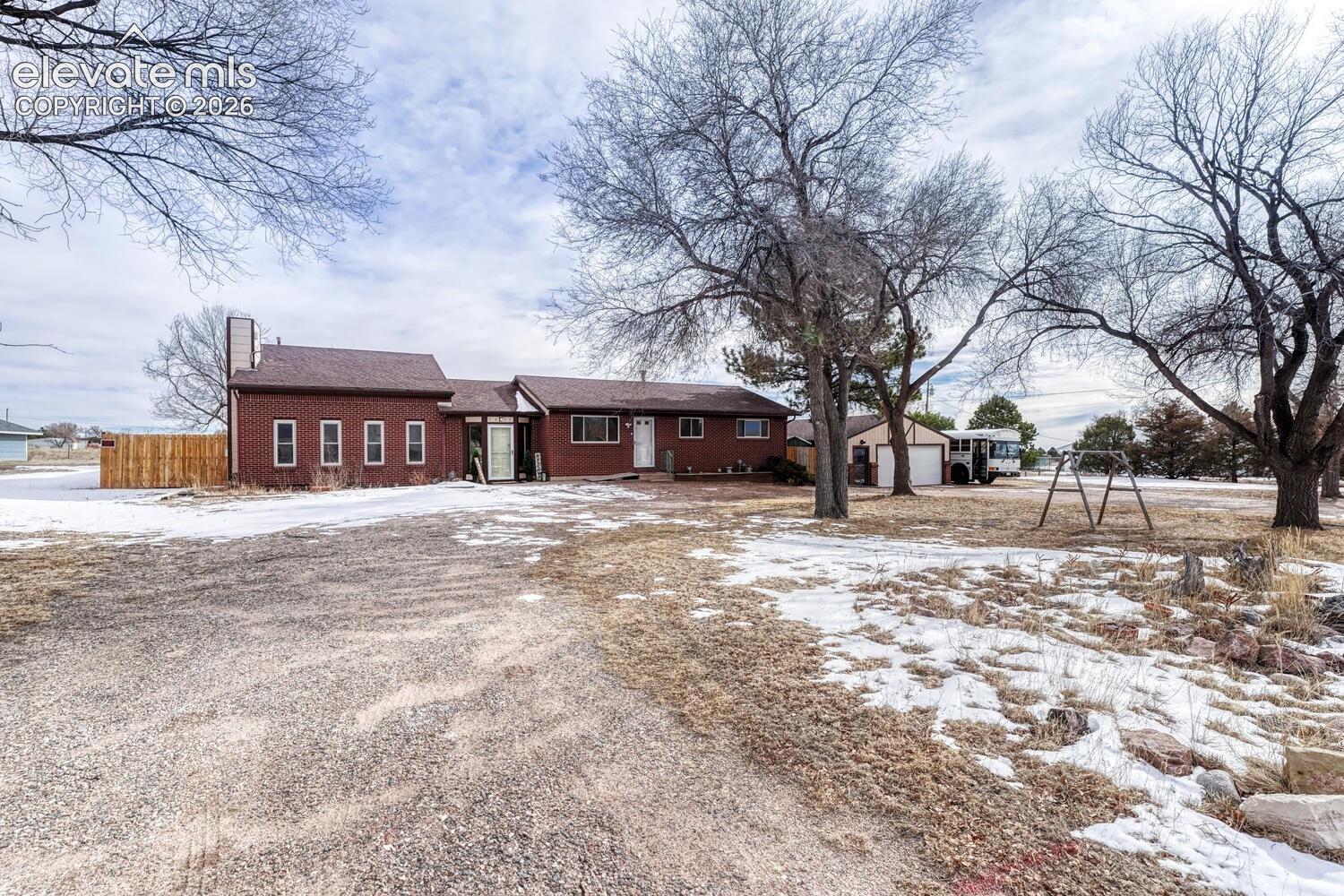 Circular Driveway with huge detached garage with attached shed and workroom.