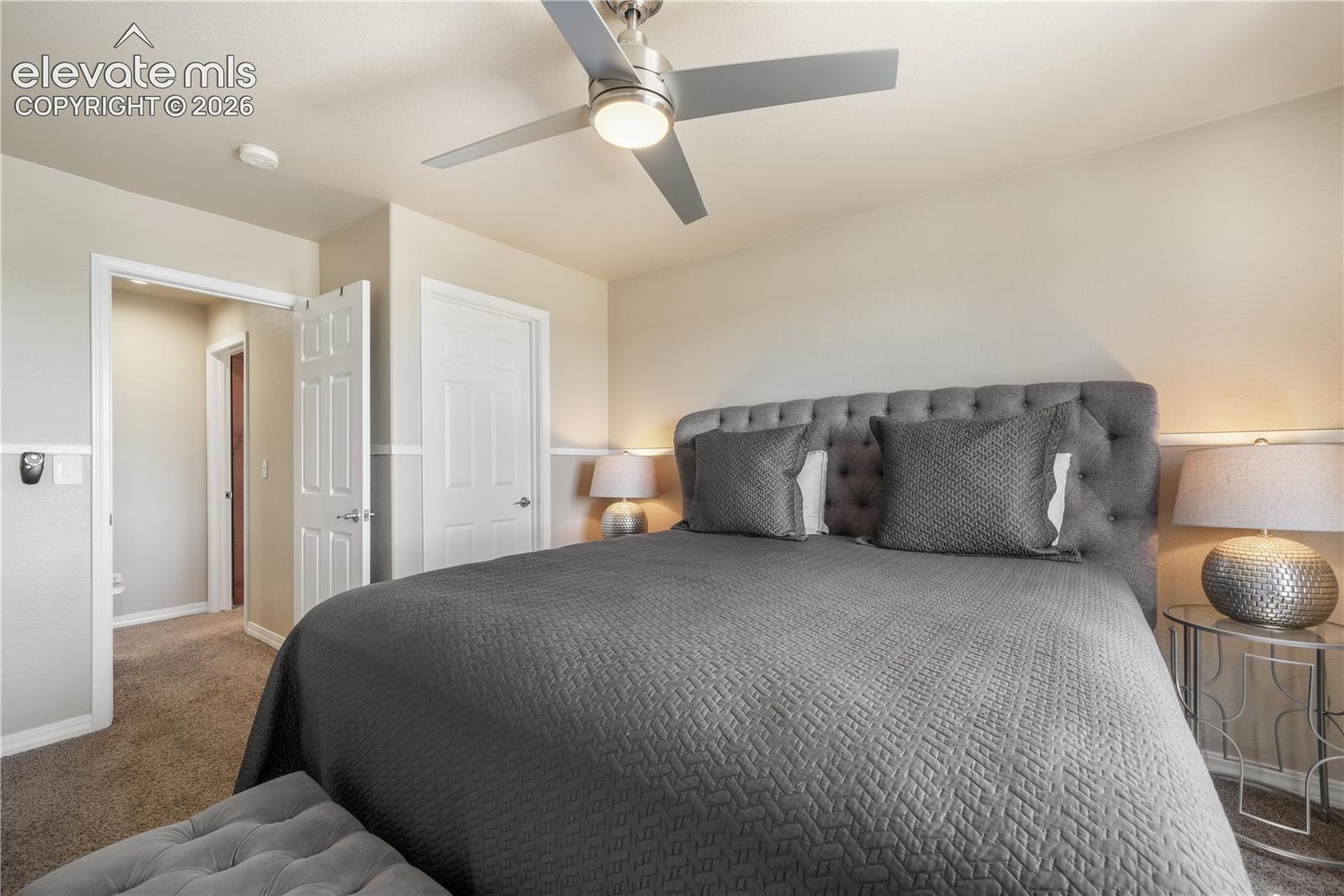 Upper Level Bedroom with Ceiling Fan and Walk-in Closet 
