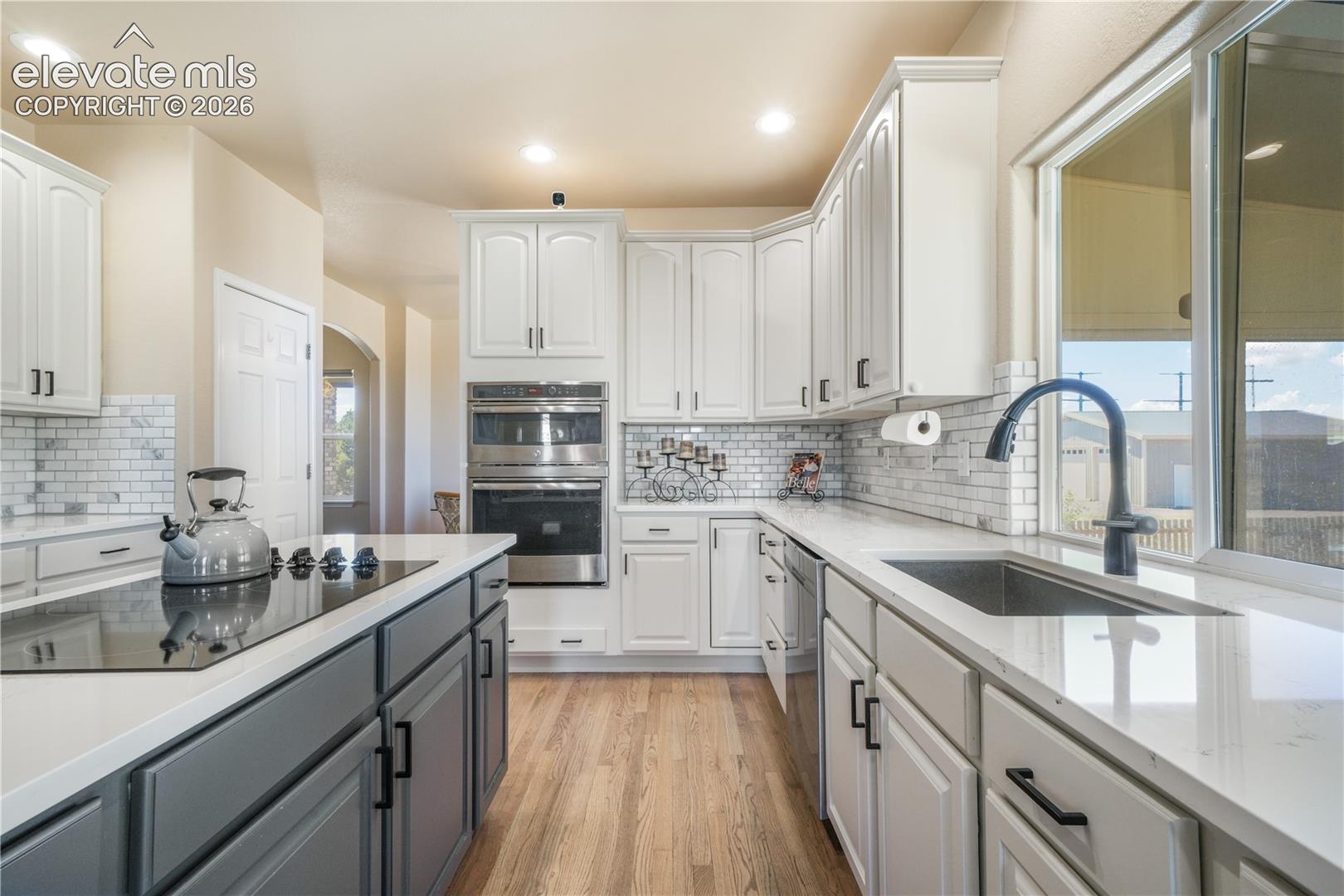Beautiful Backsplash with Large Farmhouse Sink.
