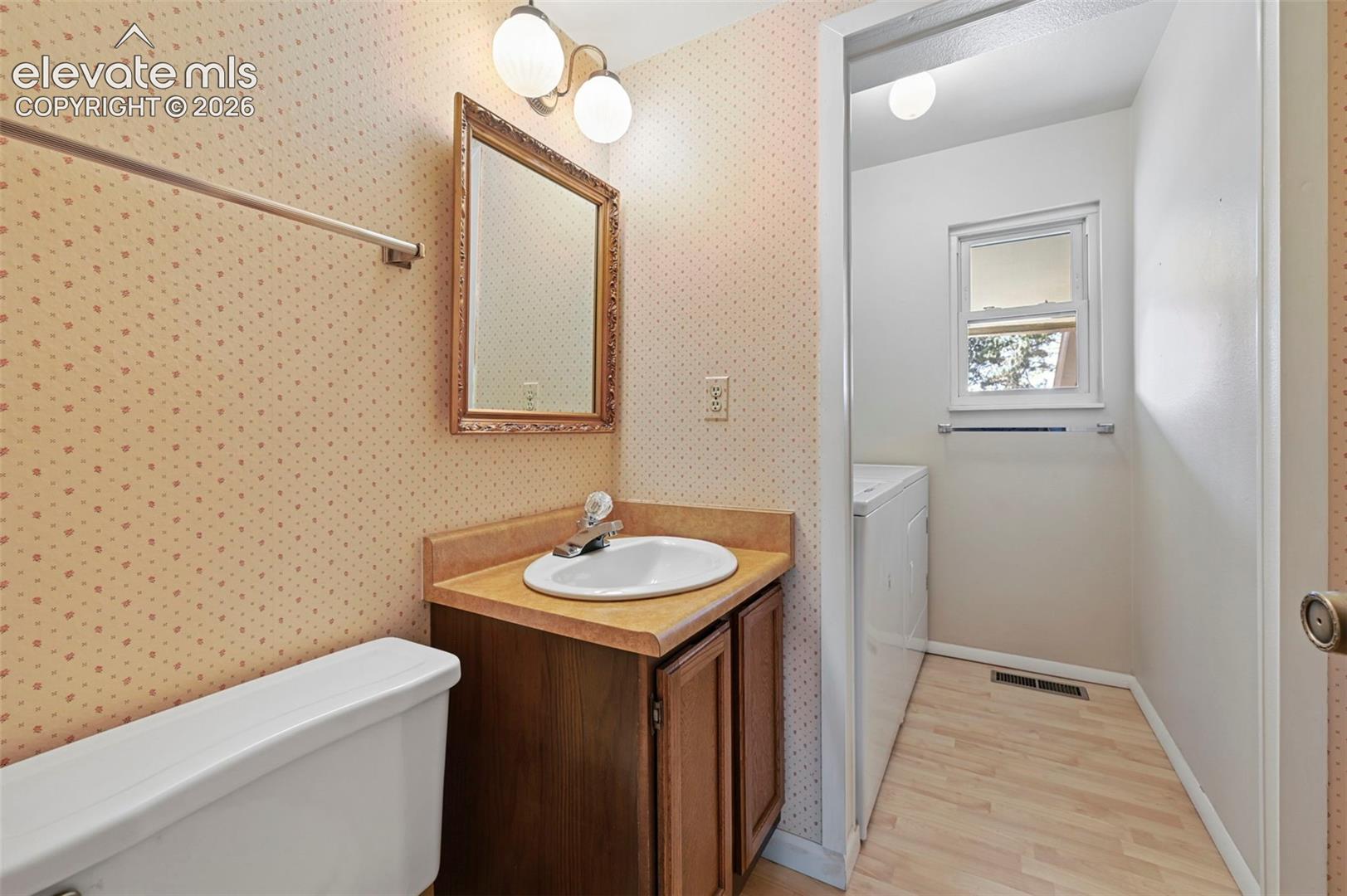 Main level Bathroom with conveniently located washer and dryer