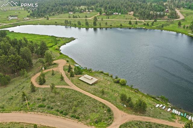 Aerial view of property's location with a large body of water