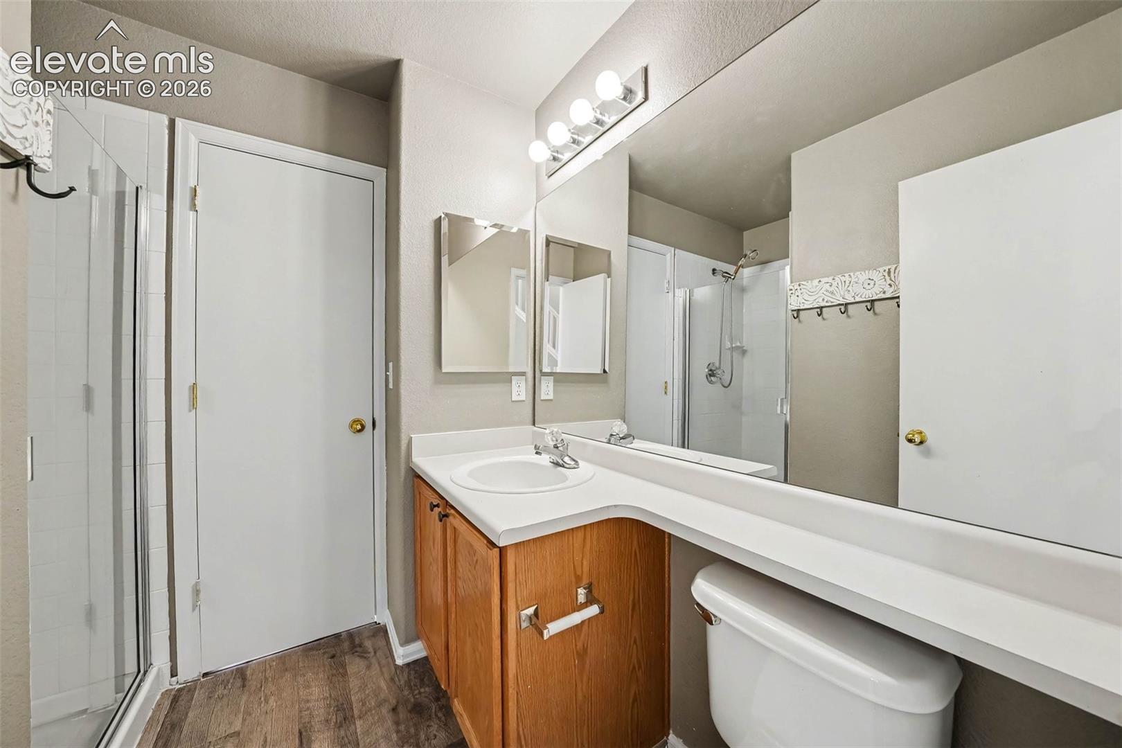 Wood-finish flooring with a glass-enclosed shower