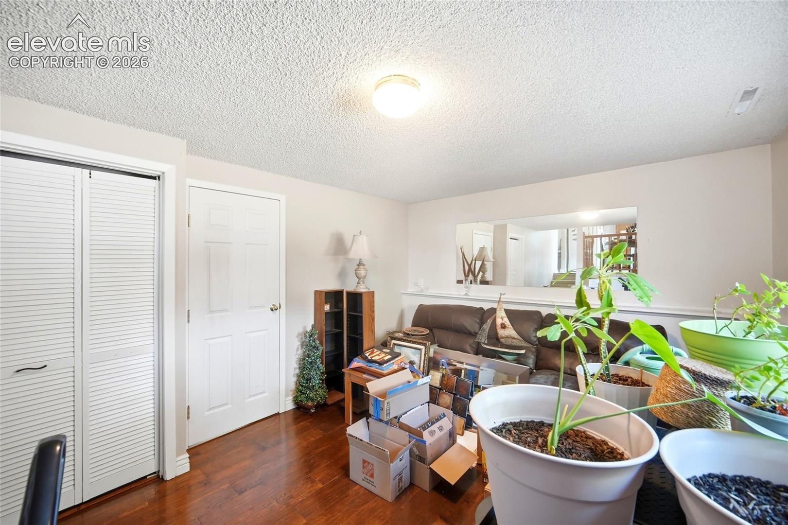 Lower level family room with wood flooring