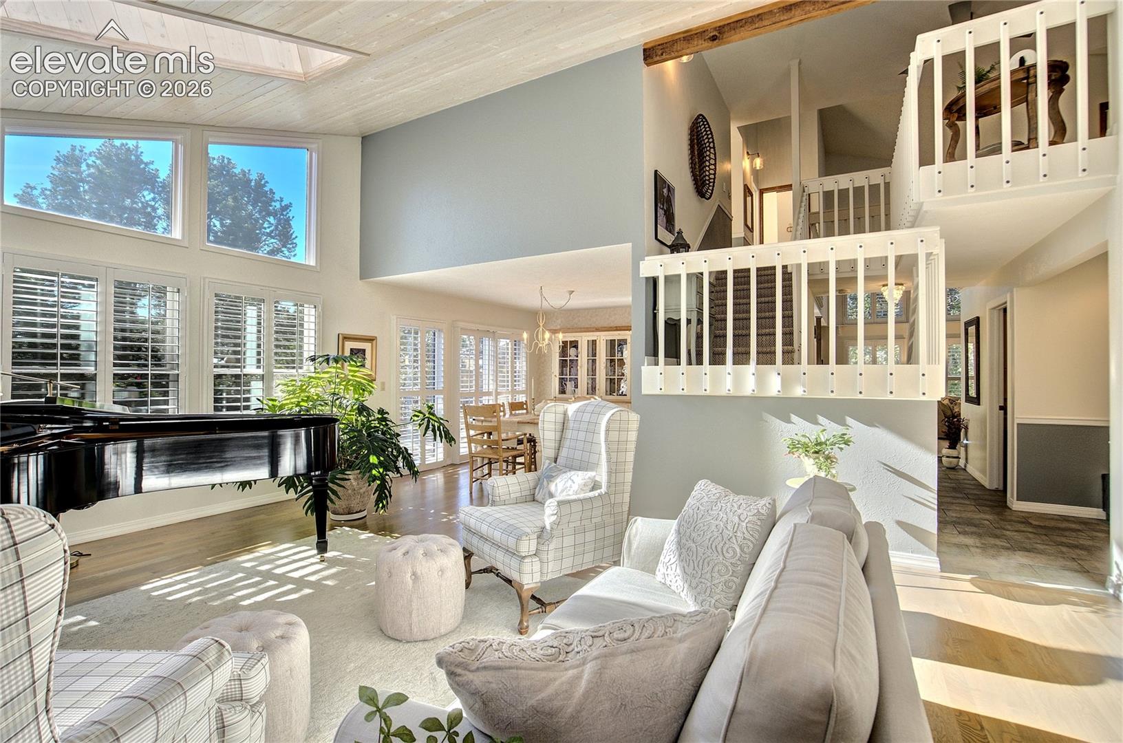 Open sightlines reveal the home's exceptional sense of scale, with the upper level adding dimension above.