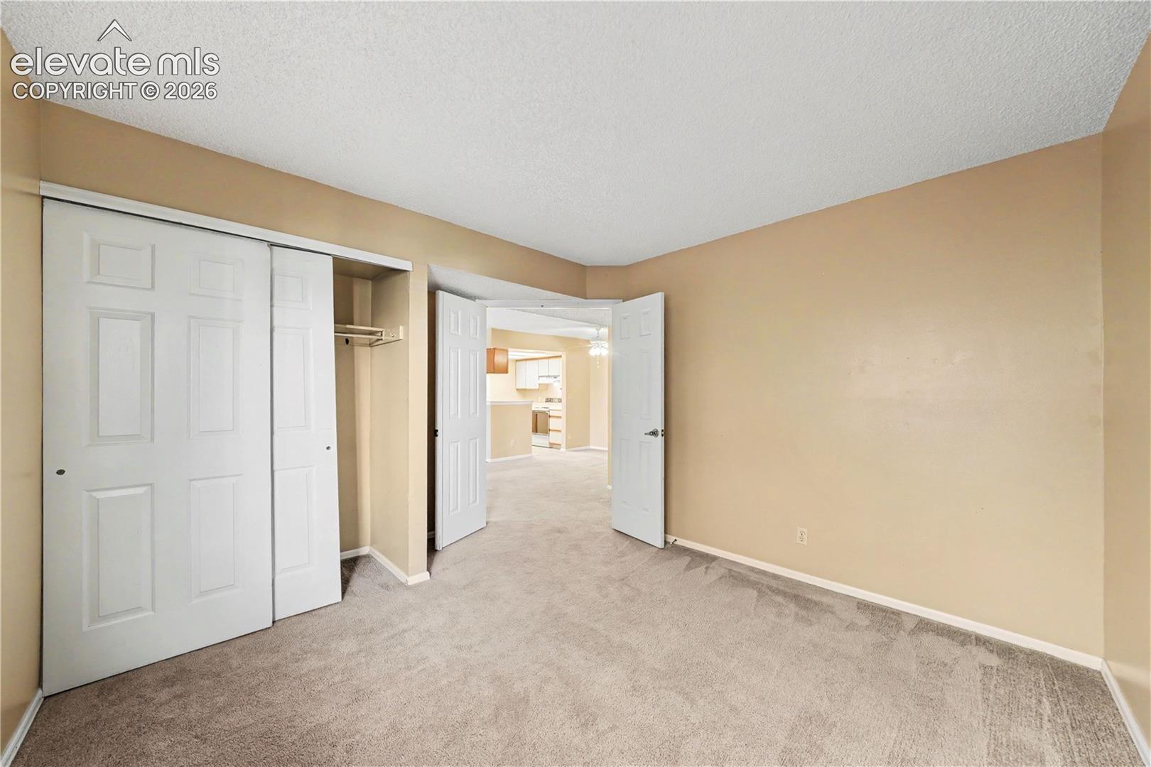 Carpeted bedroom with neutral walls