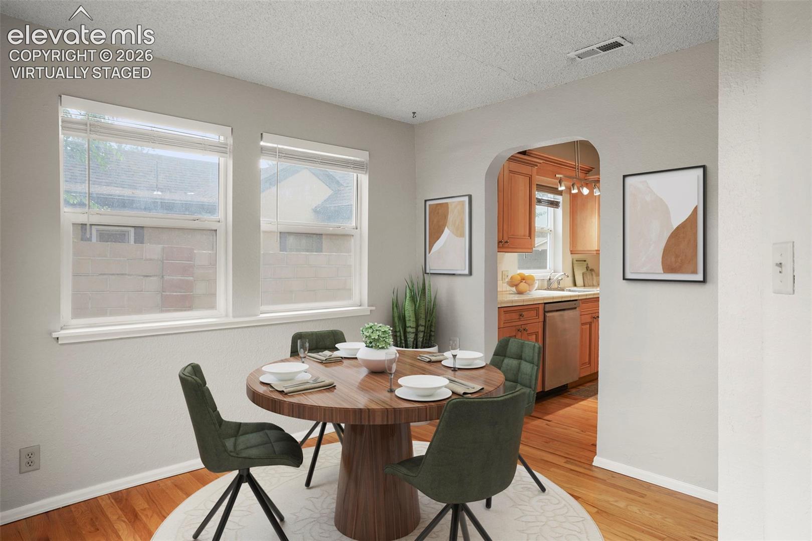 Dining nook has hardwood floors and walk-out to the back patio! (Virtually Staged) 