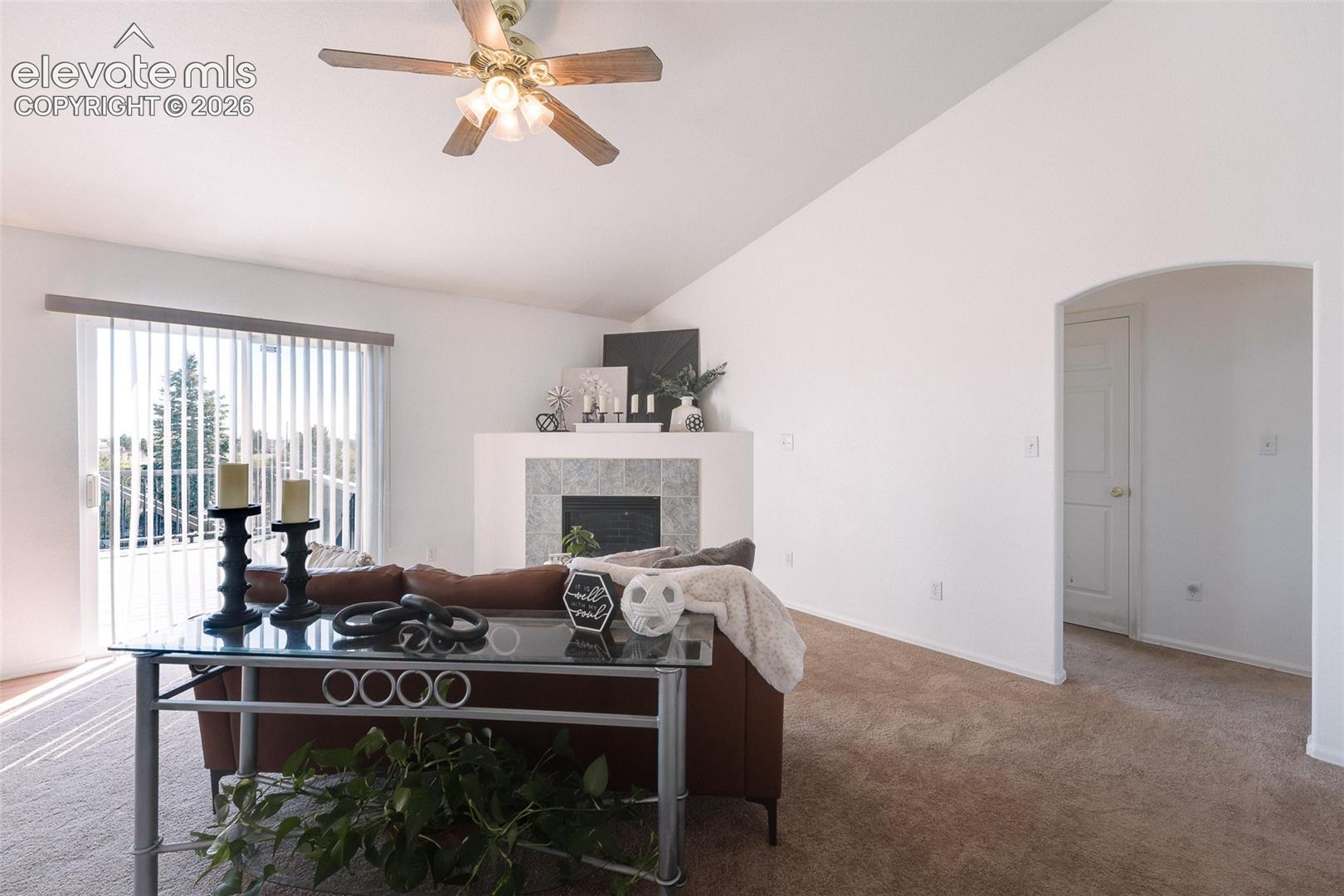 Walk Out Living Room with arch way into the main level Bedrooms.
