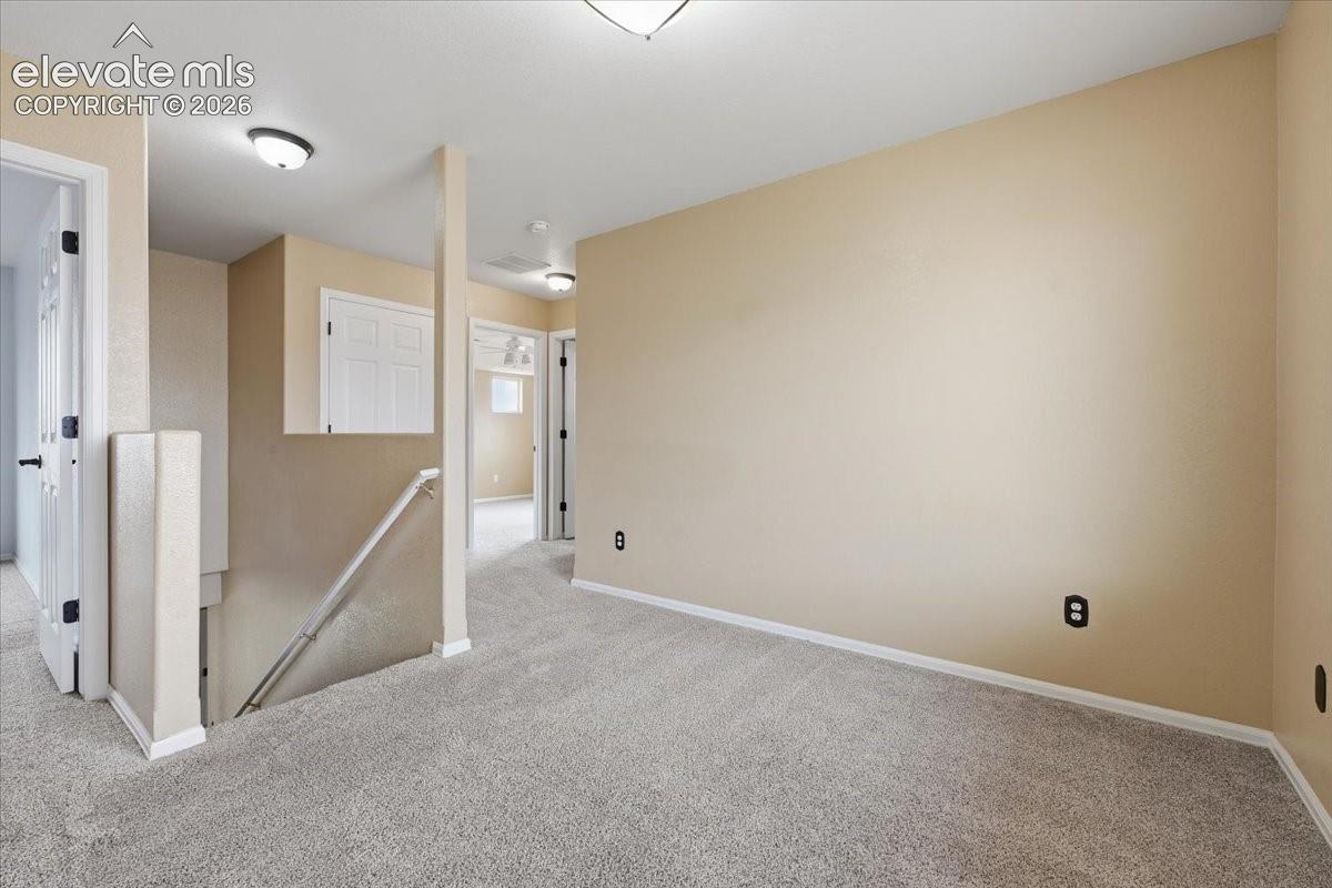 Neutral-toned walls complement the gray carpeting