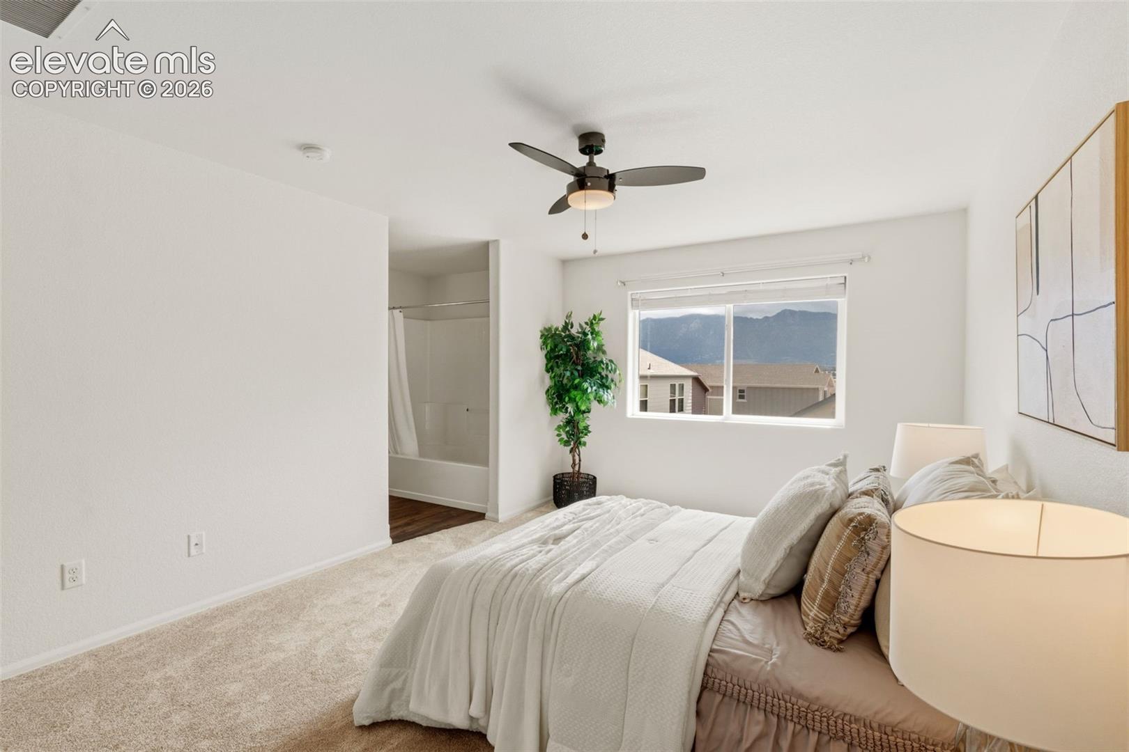 The primary suite’s soft carpeting and abundant natural light create a peaceful oasis at the end of a long day