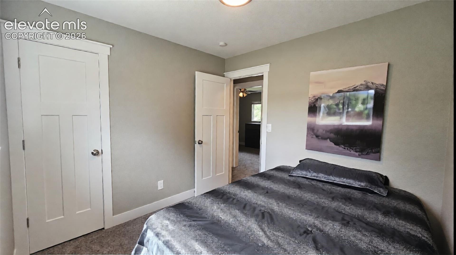 Neutral wall paint, white trim, and carpeted flooring