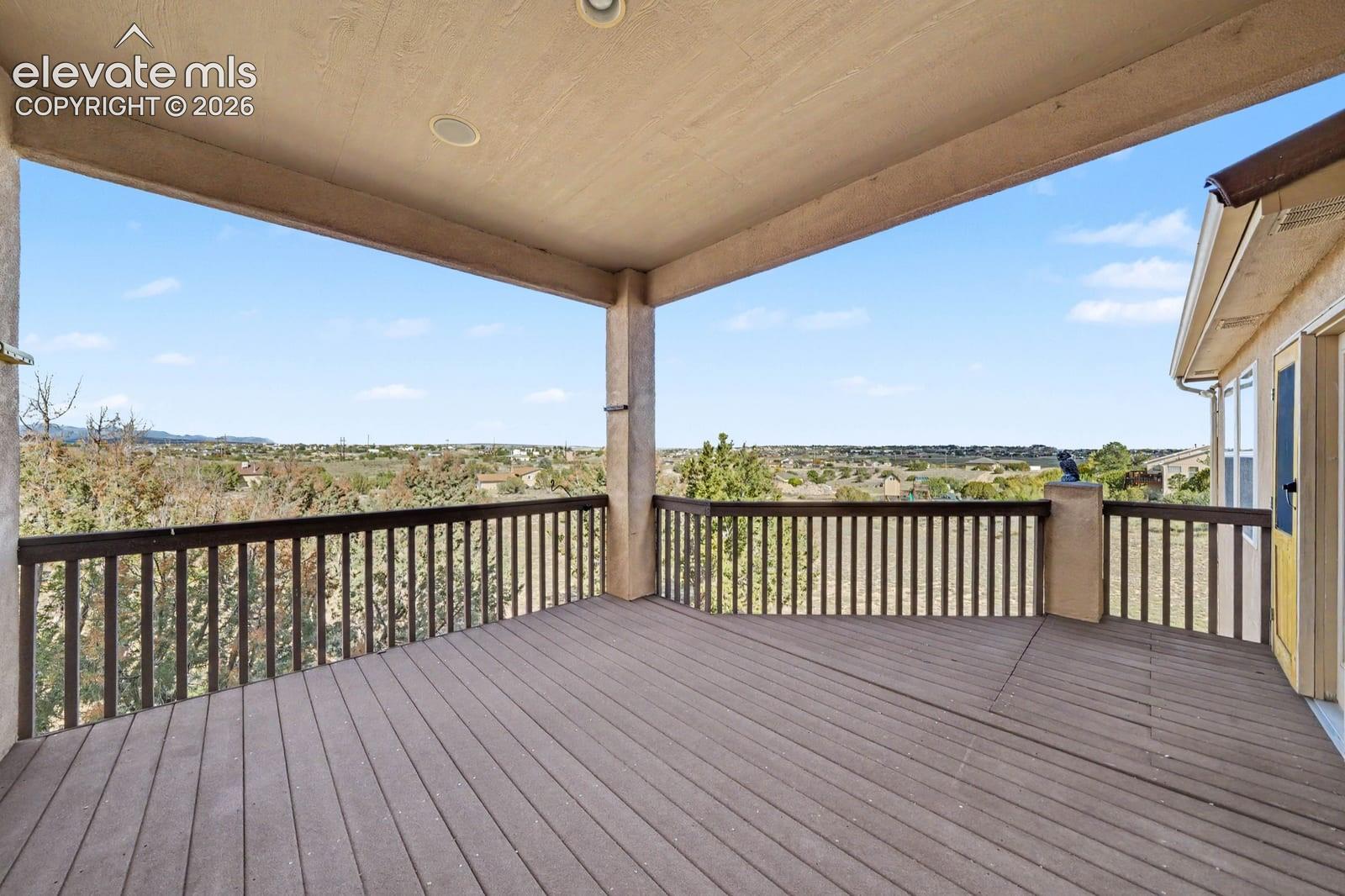 Covered deck featuring wood-finish flooring, recessed lighting, and a perimeter railing