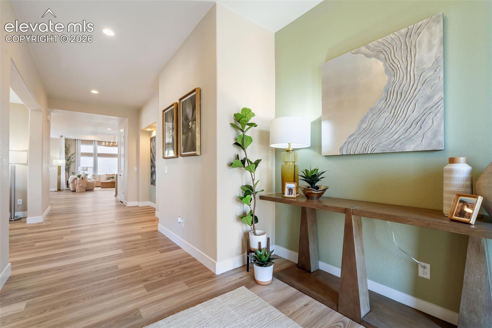 Interior space featuring wood-finish flooring, recessed lighting, and an accent wall