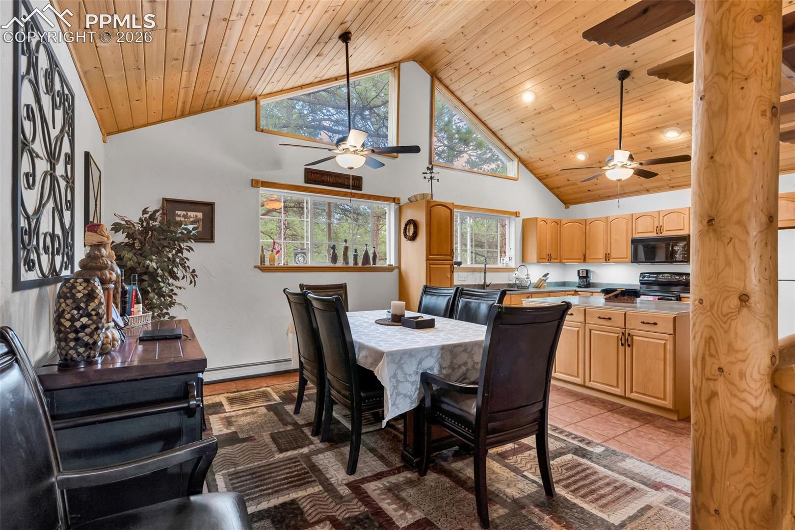 Dining room and kitchen have vaulted ceilings with wood ceiling planks