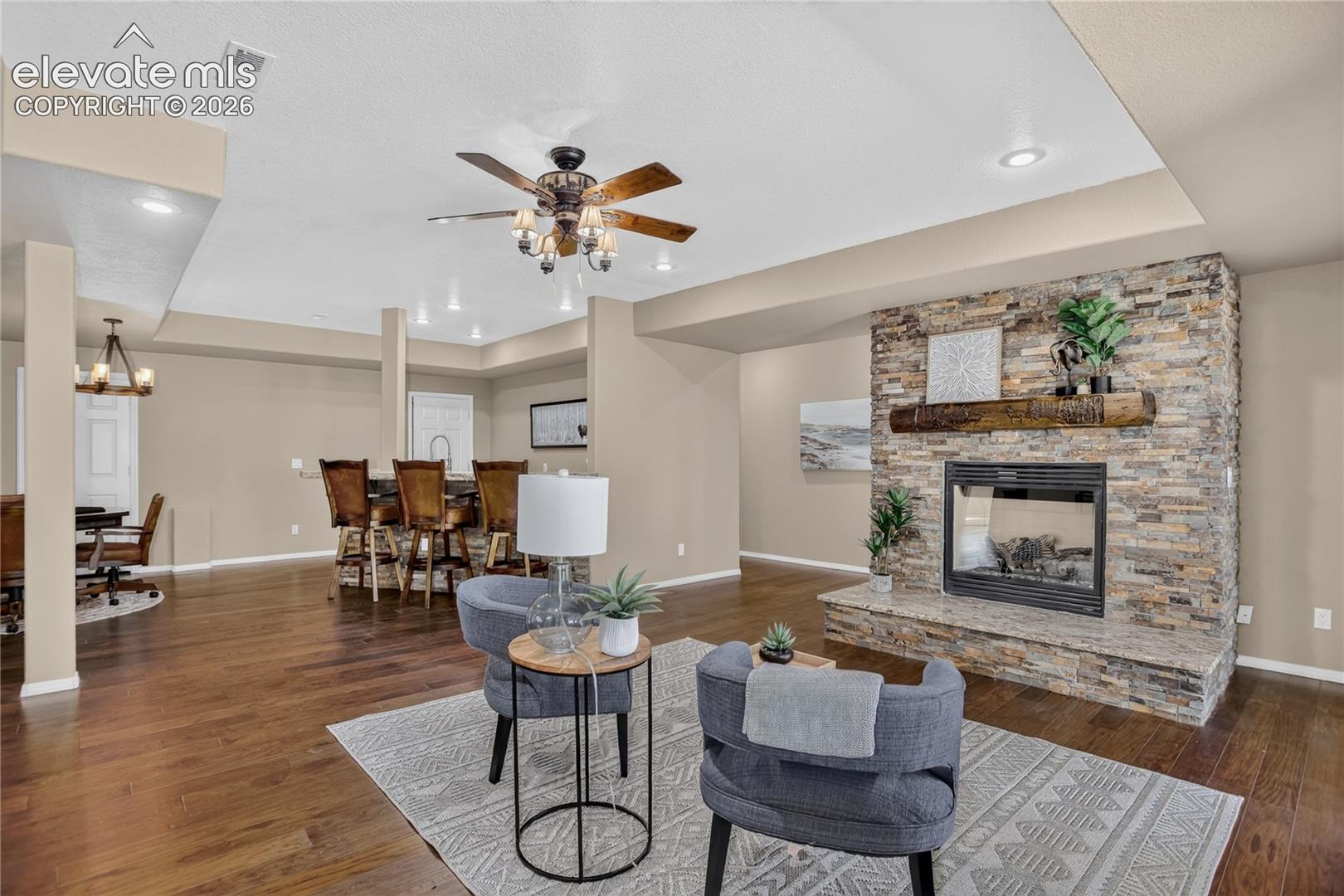Family room includes gas fireplace w/ custom mantle & chiseled-edge granite hearth