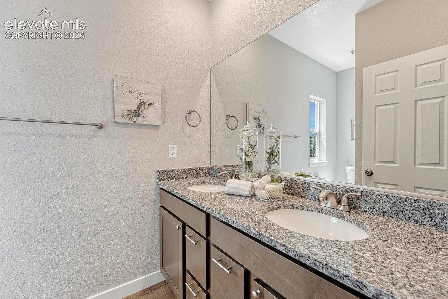 En suite primary bathroom offers double vanity with undermount sinks. Pick your cabinetry, stone countertop, flooring and paint to suite your style.