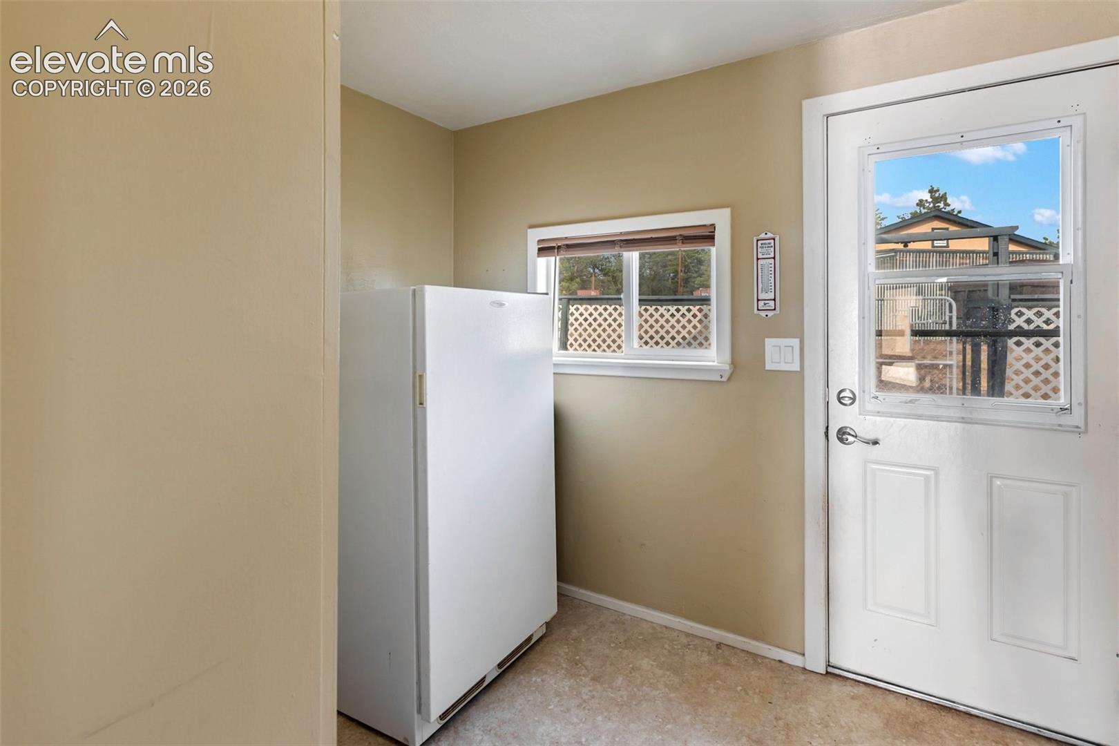 Mudroom entry area with freezer and storage