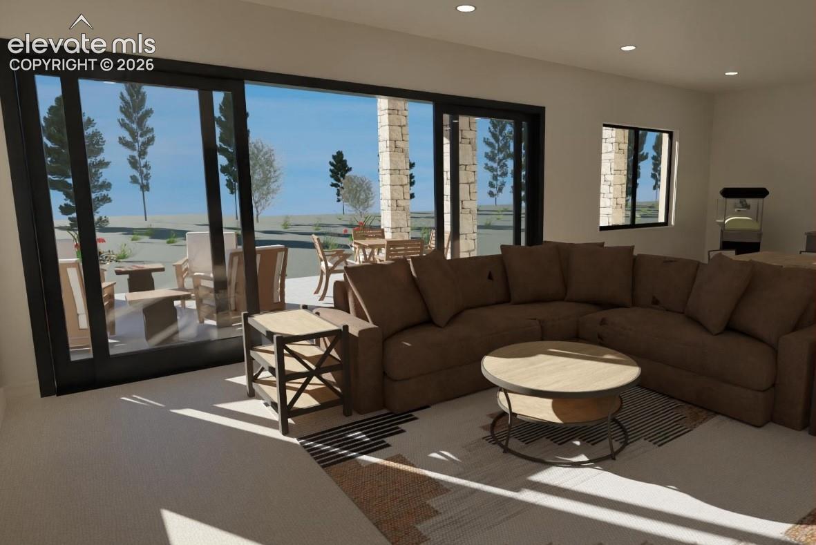 Recessed ceiling lighting, large format sliding glass doors, white walls, and a stone-clad exterior patio