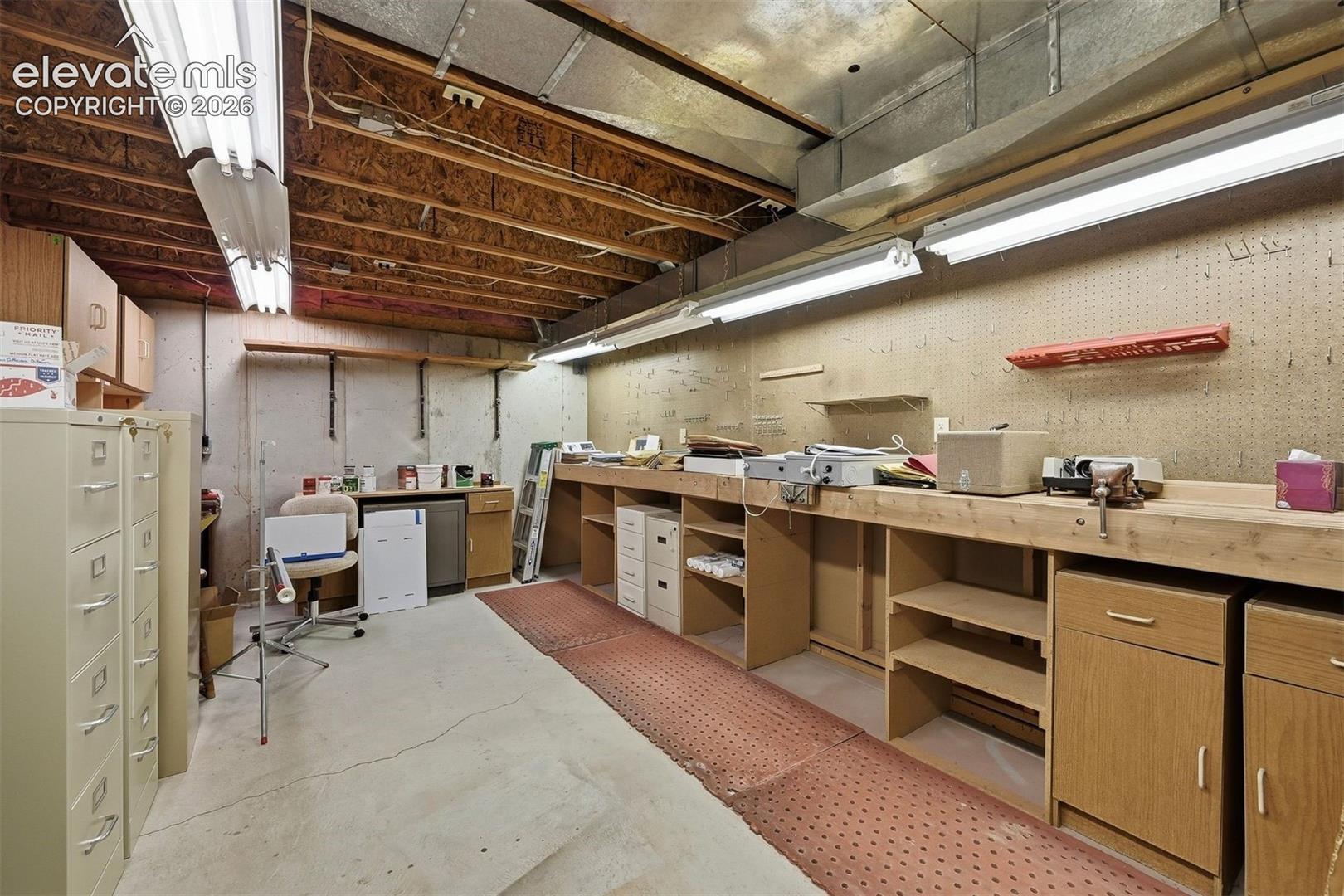 Unfinished mechanical room with shop facilities. 