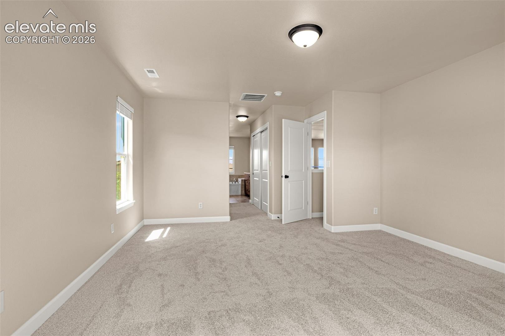 Another look at the spacious Primary Suite with His and Hers closets!