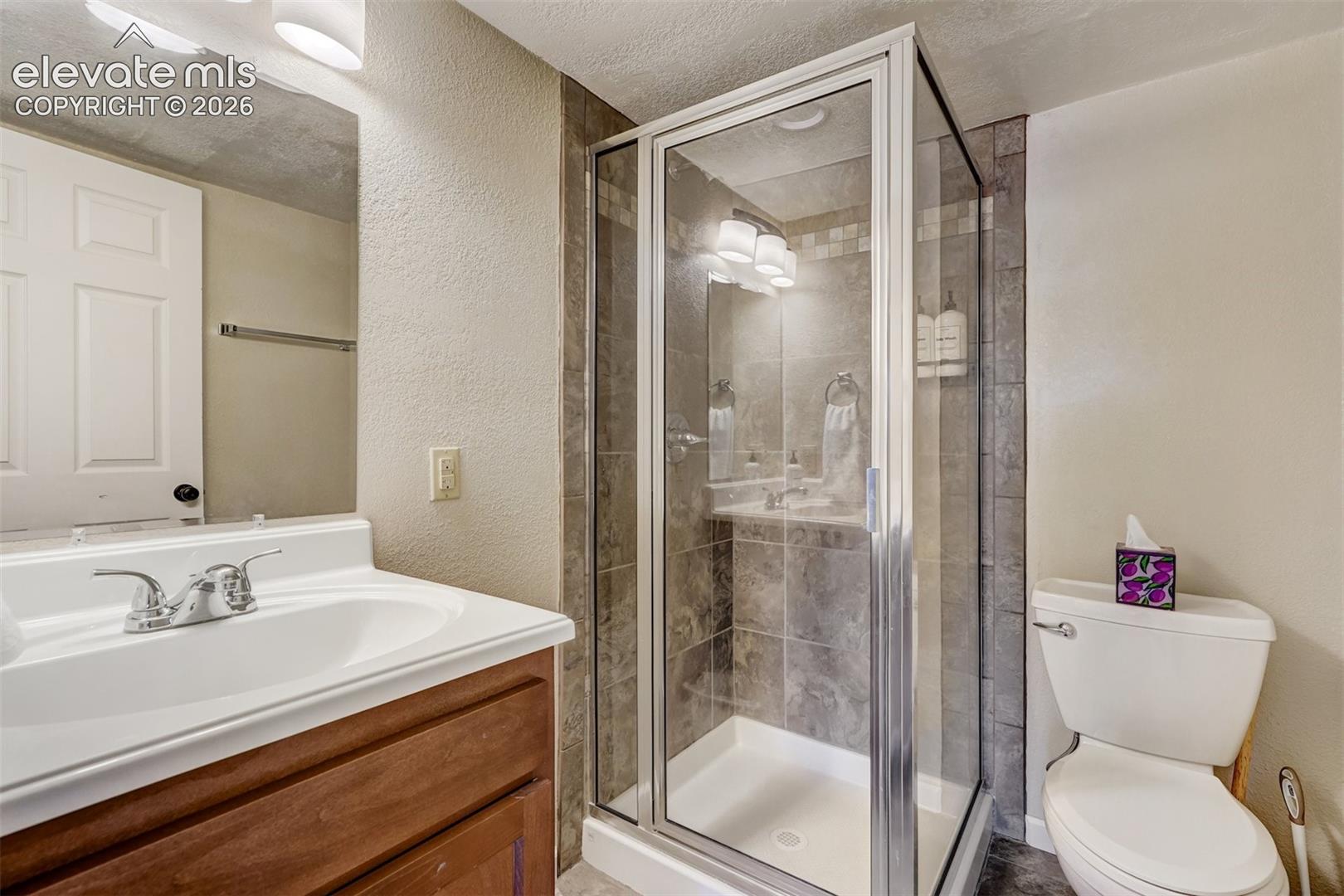 Glass-enclosed shower with tiled walls and a built-in niche