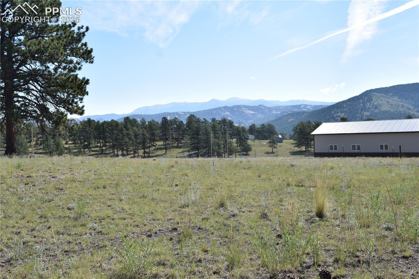View of mountain backdrop with rural landscape