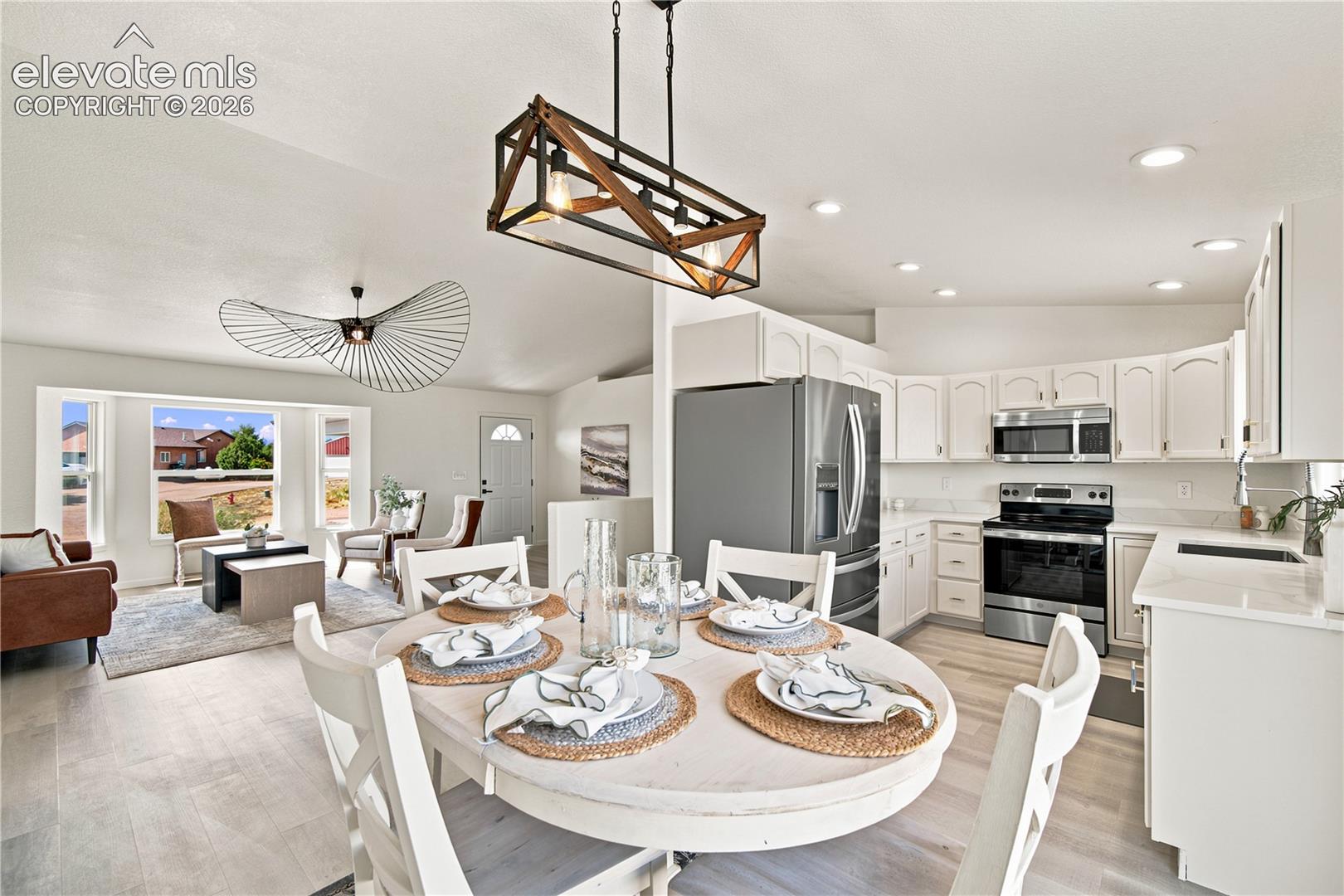 Open concept living space featuring a dining area, kitchen, and living room