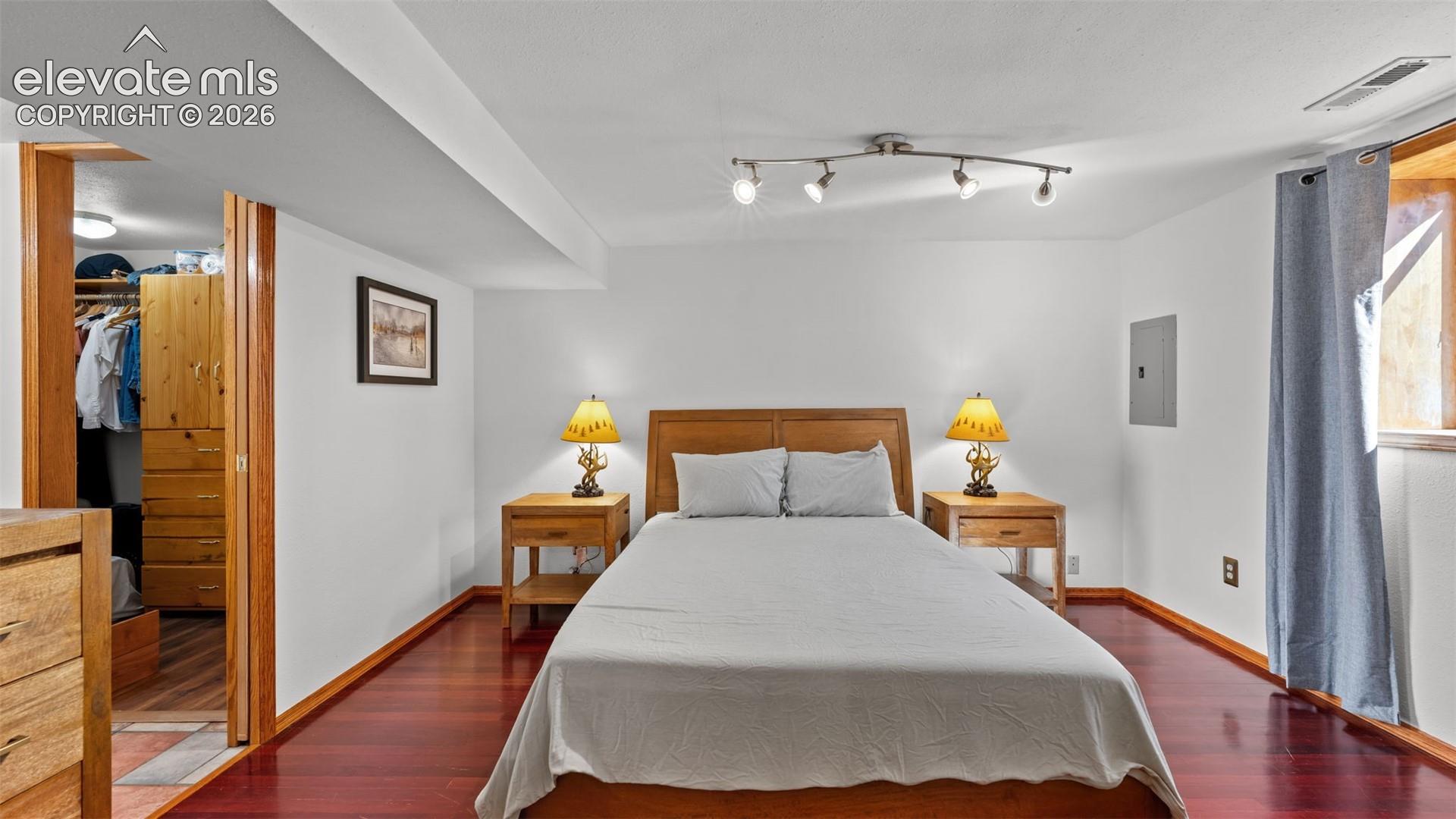 Wood-finish flooring, recessed multi-directional lighting, and wooden door framing
