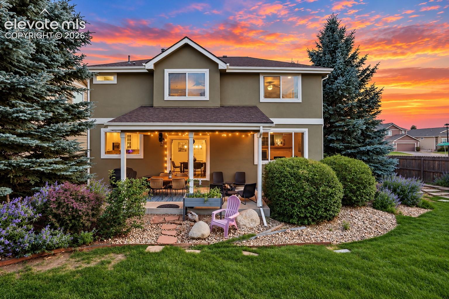 Mature landscaping and usable outdoor space create an inviting setting just beyond the back door.