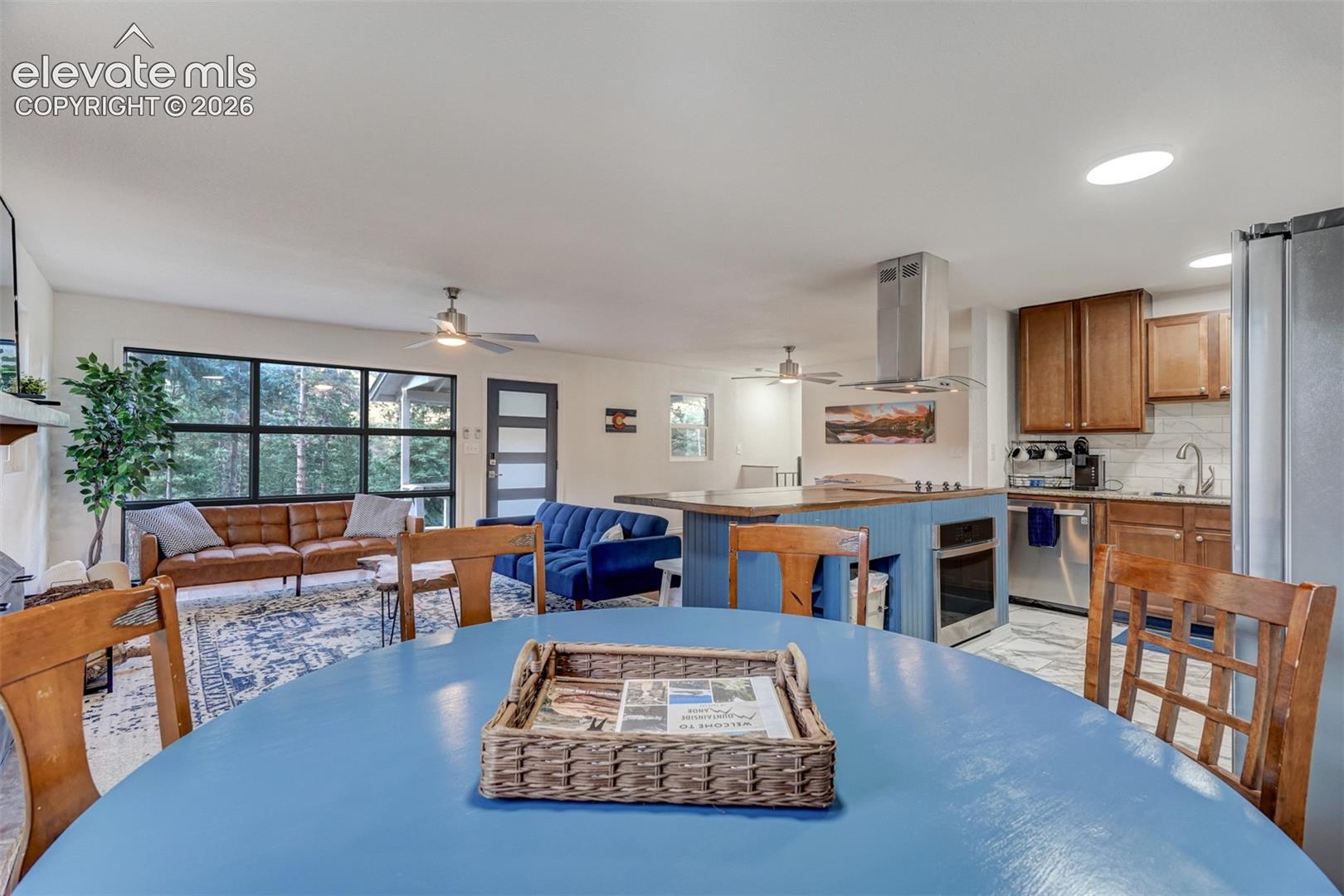 Open concept living space featuring a kitchen island, recessed lighting, and a modern range hood