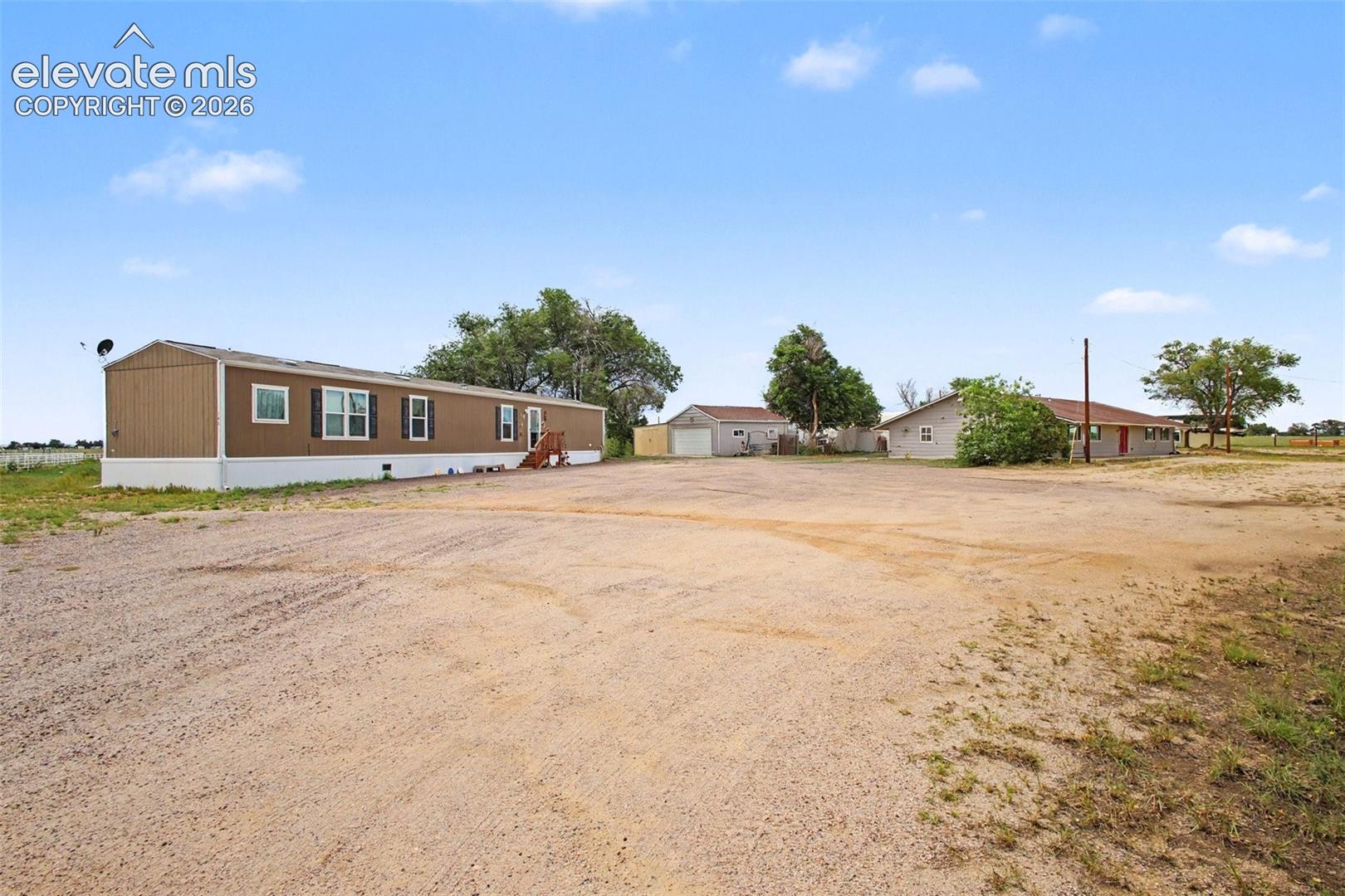 Abundant parking between the 2019 manufactured home and main home, with convenient access to the detached 2 car garage/workshop and attached to the garage shed.