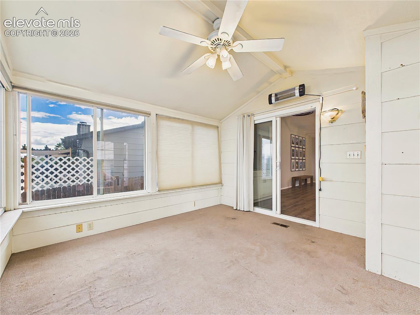 Versatile enclosed sunroom with direct access to the deck and seamless connection to the main living area, extending the home's indoor-outdoor lifestyle.