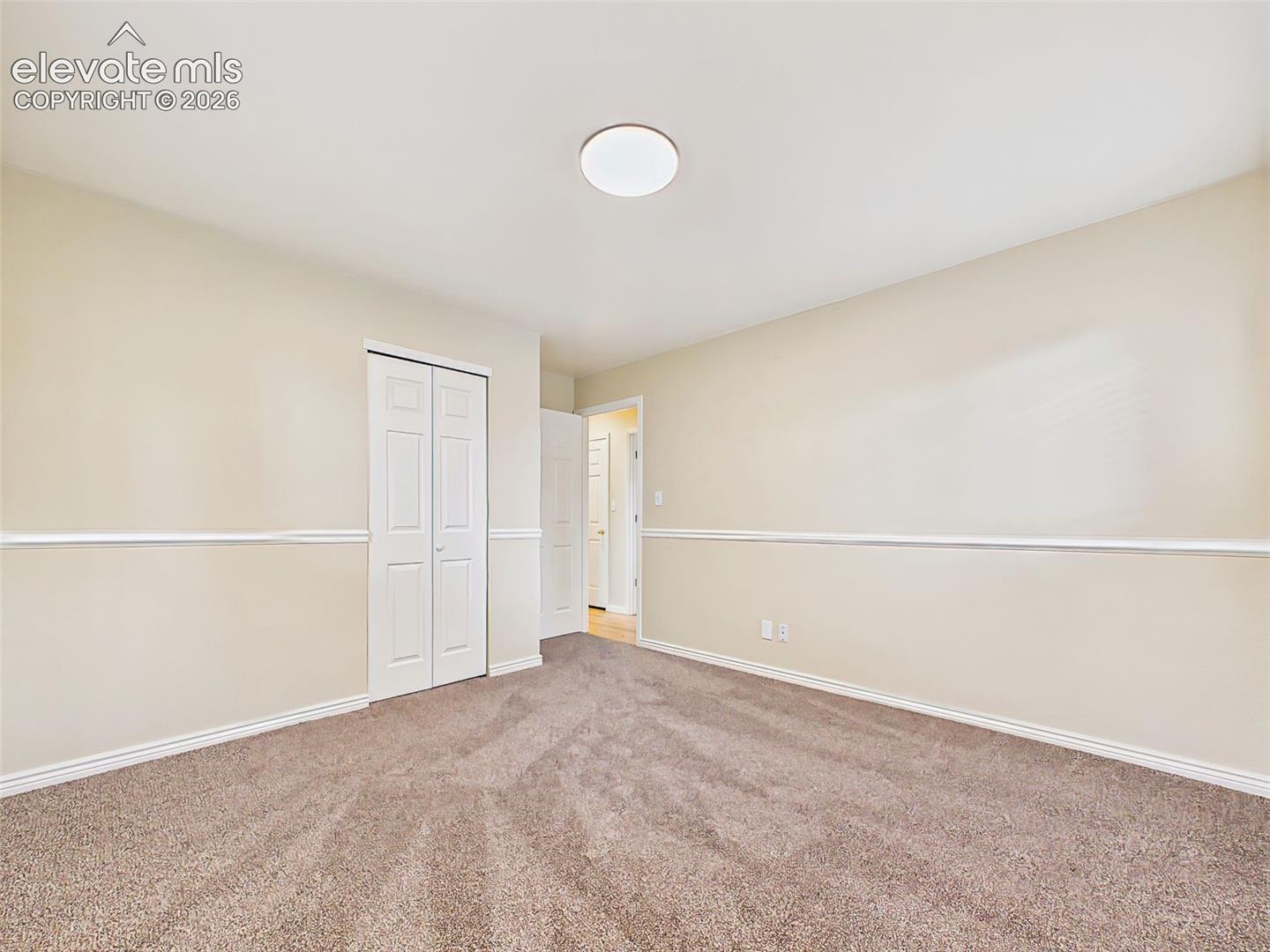 Another view showcases the room's generous proportions, abundant natural light, and fresh, move-in-ready finishes.