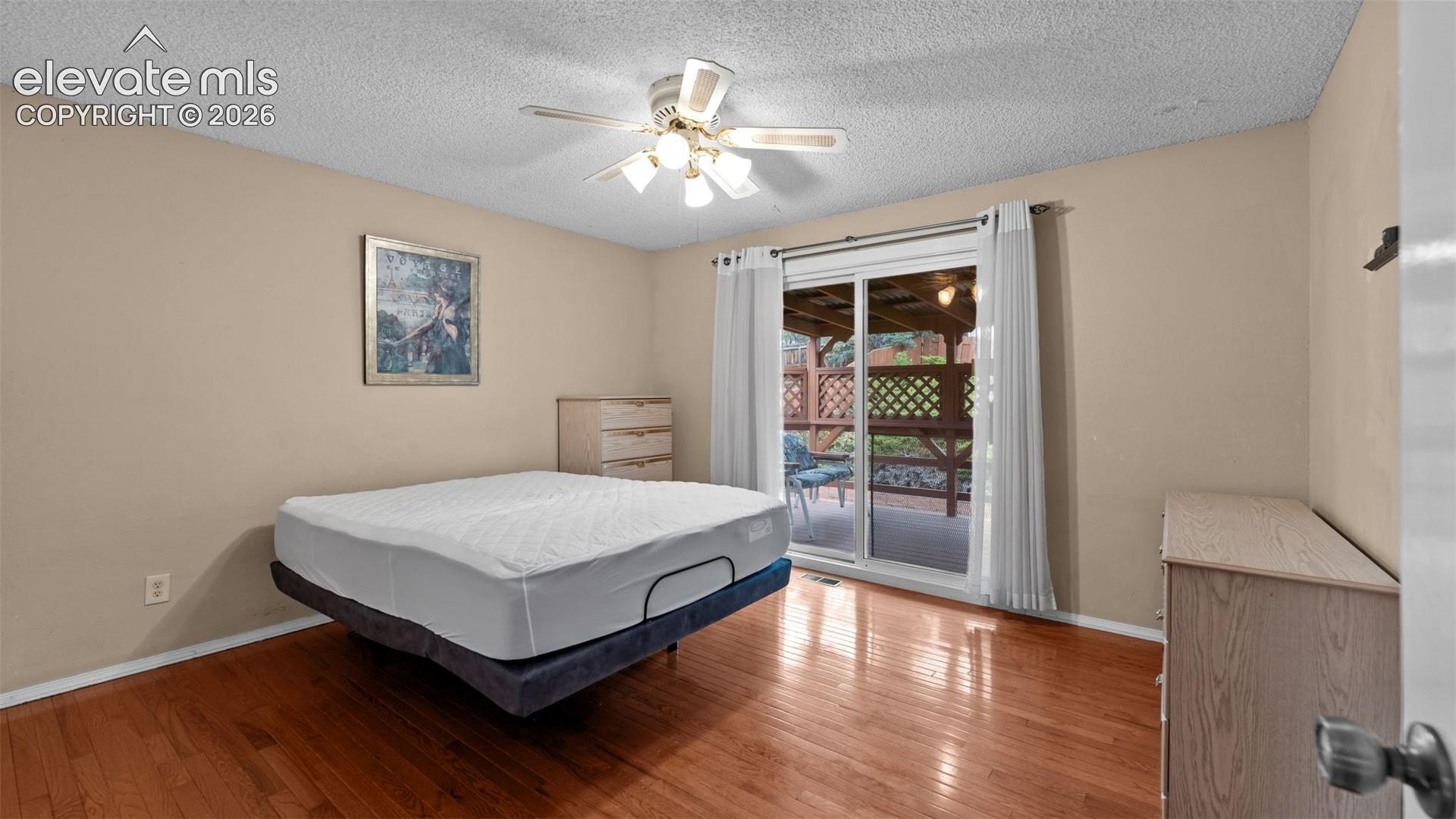 Large upper bedroom with walk-out to the large covered deck.
