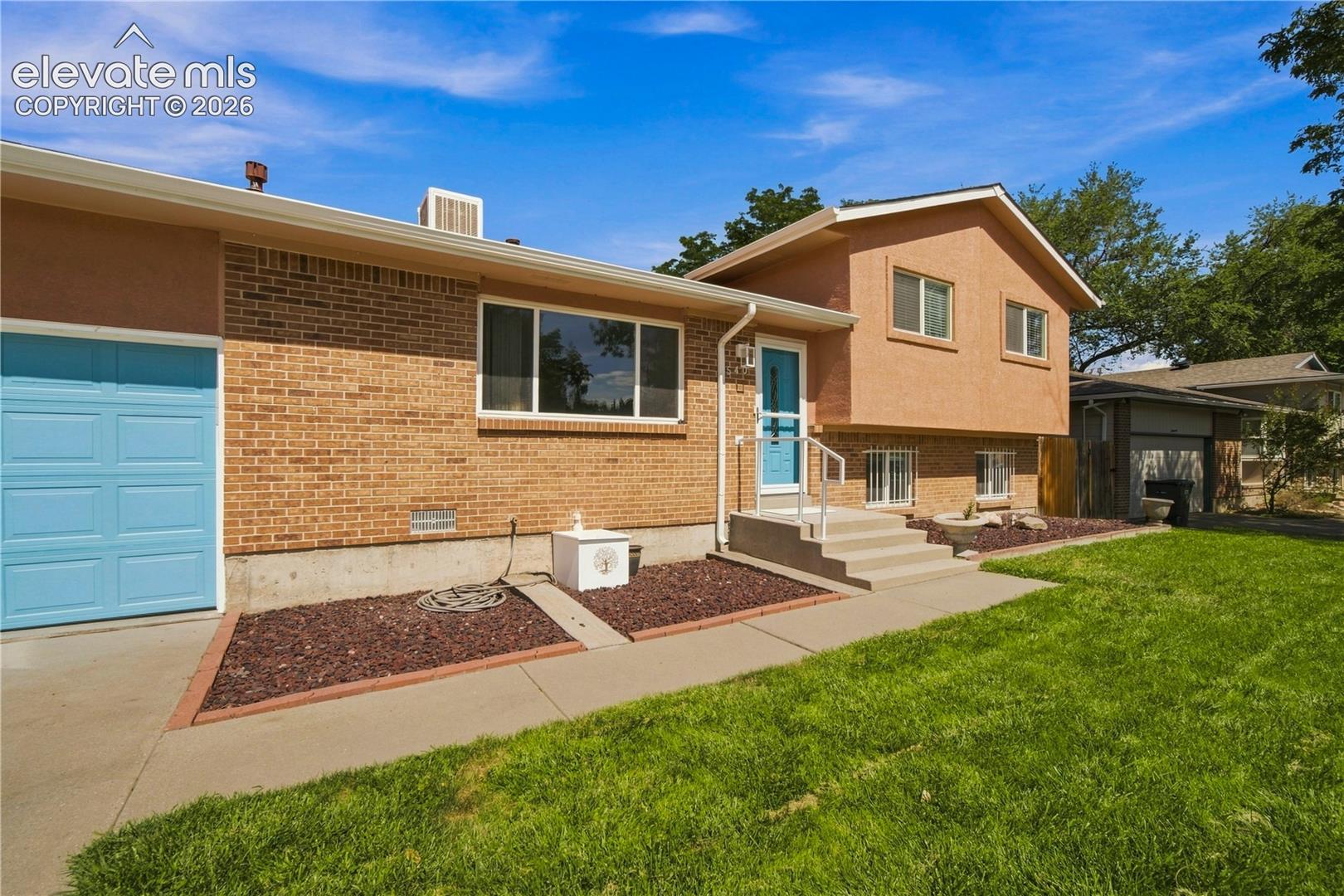 Brick and stucco exterior with multiple windows