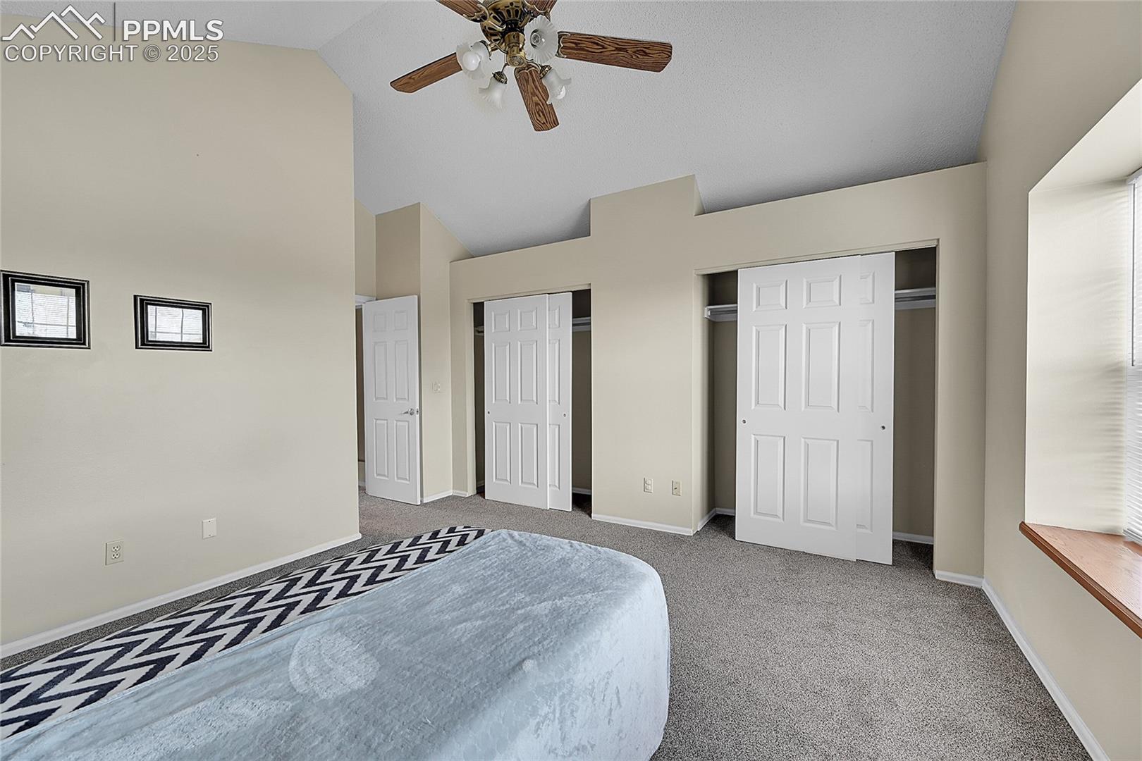Primary bedroom two closets and ceiling fan