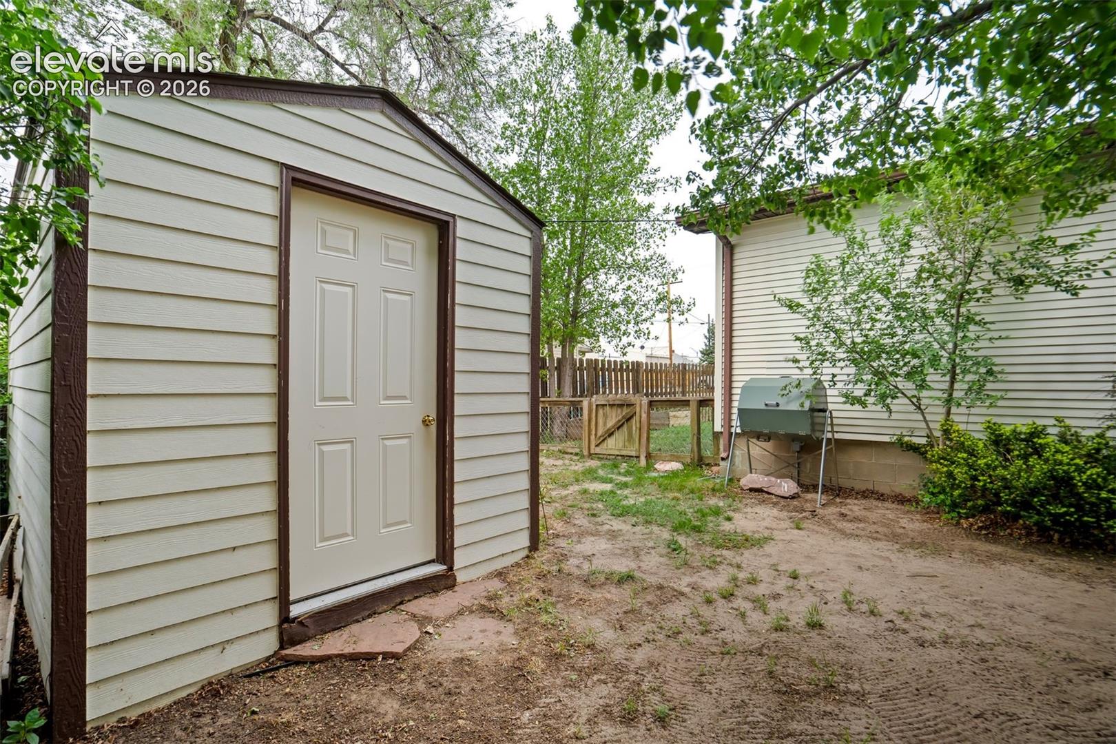 Storage shed provides additional space for tools and outdoor equipment.