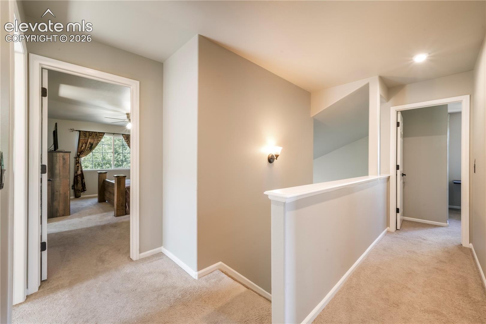 Upstairs view of primary bedroom and additional bedrooms
